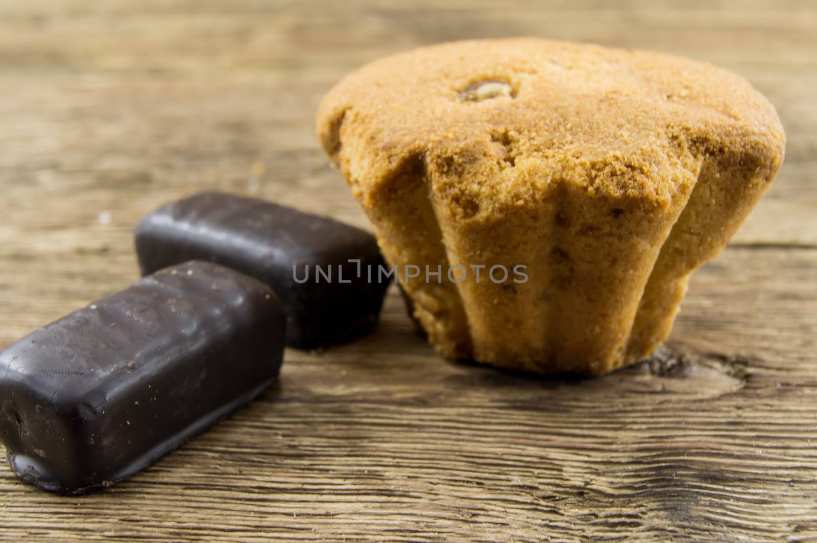 Tasty cupcake on wooden table by serhii_lohvyniuk