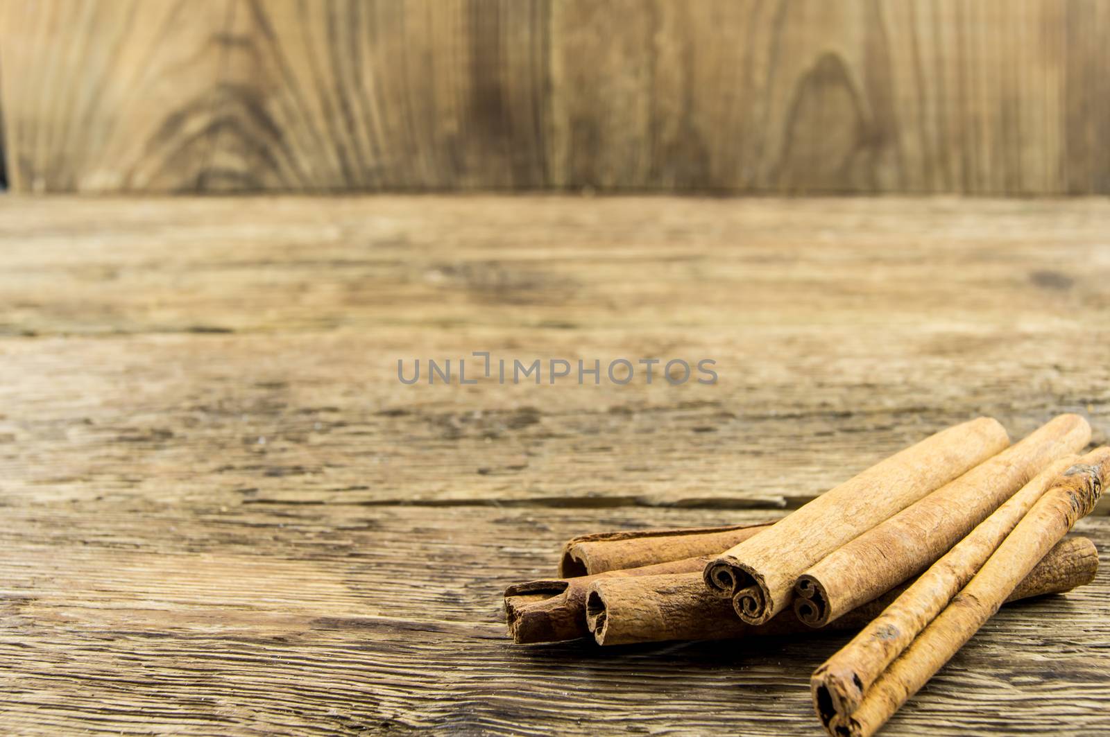 Close up of cinnamon sticks on rustic wood . For your commercial and editorial use.