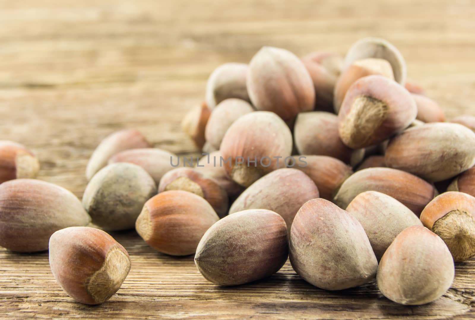 Filberts on a wooden table. Close-up shot. by serhii_lohvyniuk