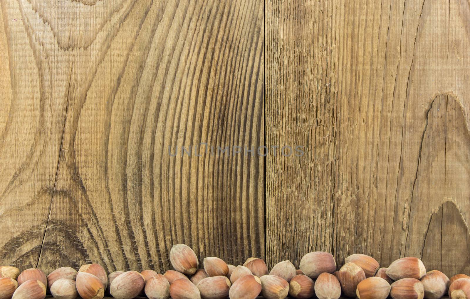 Filberts on a wooden table. Close-up shot. by serhii_lohvyniuk