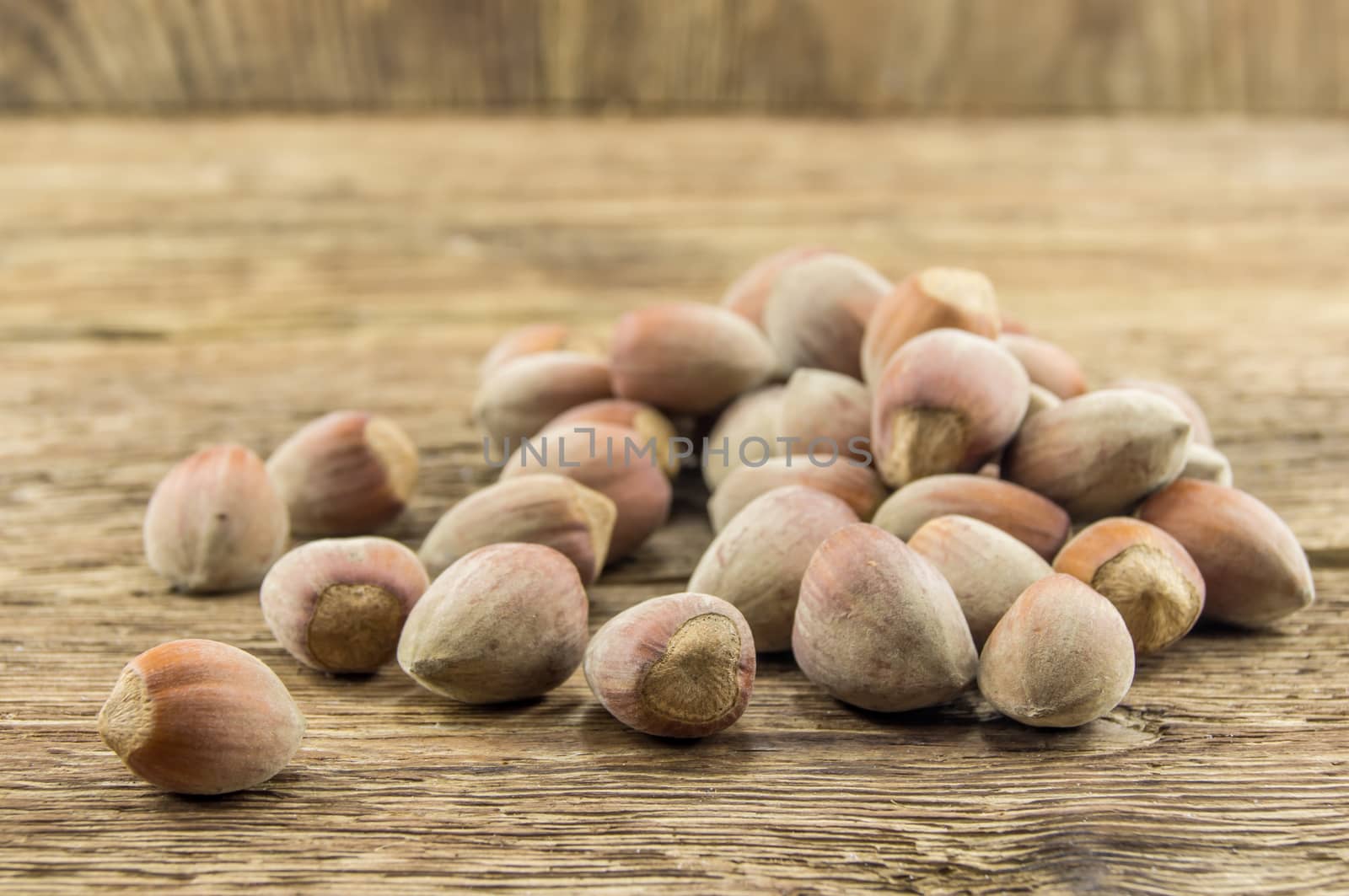 Filberts on a wooden table. Close-up shot. by serhii_lohvyniuk