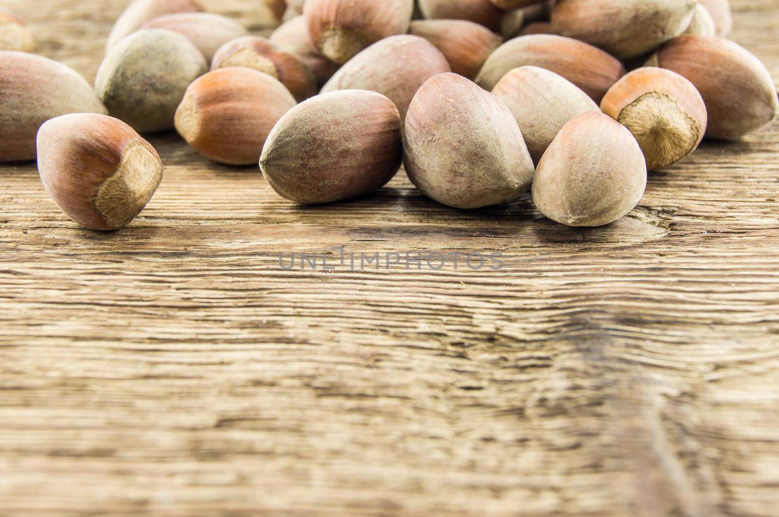 Filberts on a wooden table. Close-up shot. by serhii_lohvyniuk