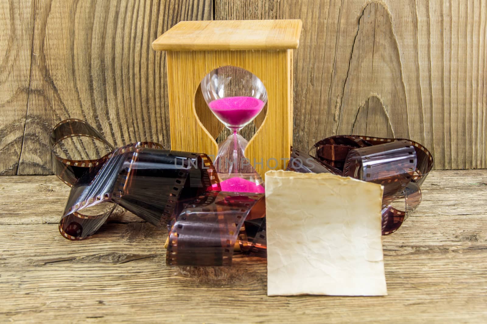 Hourglass with space for text on the wooden background.