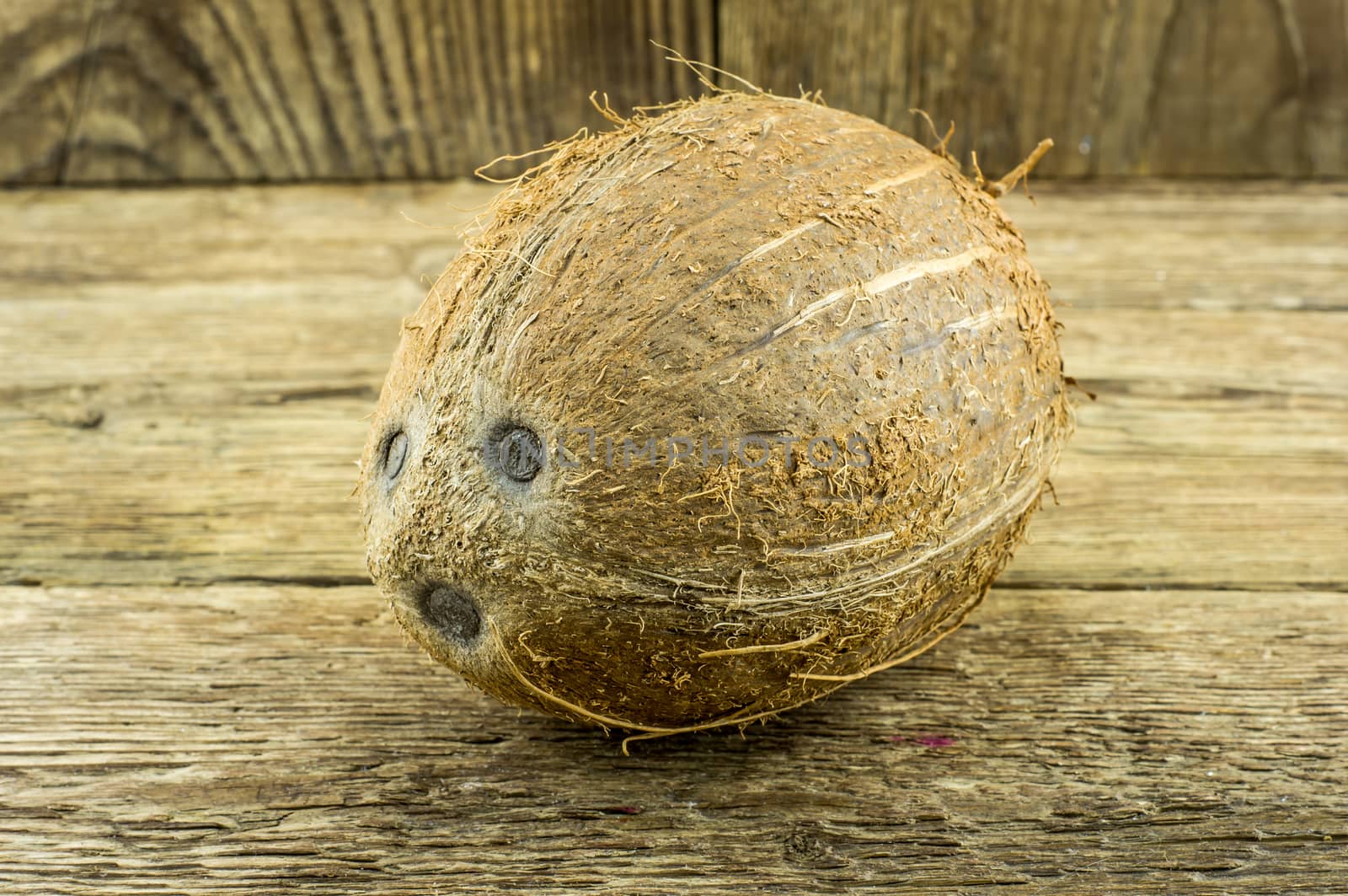 coconut and lie on a wooden background.