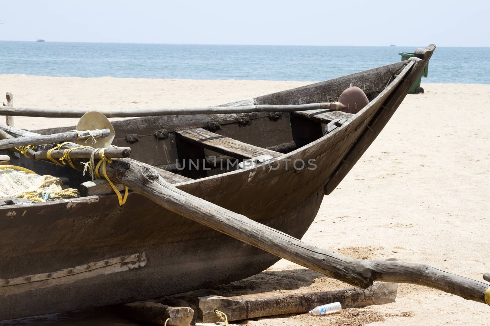 Old fishing boat standing on the sandy beach. India, Goa by mcherevan