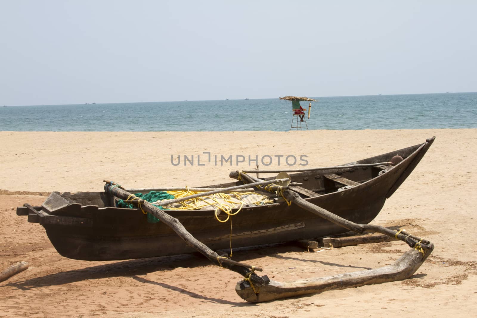 Old fishing boat standing on the sandy beach. India, Goa by mcherevan