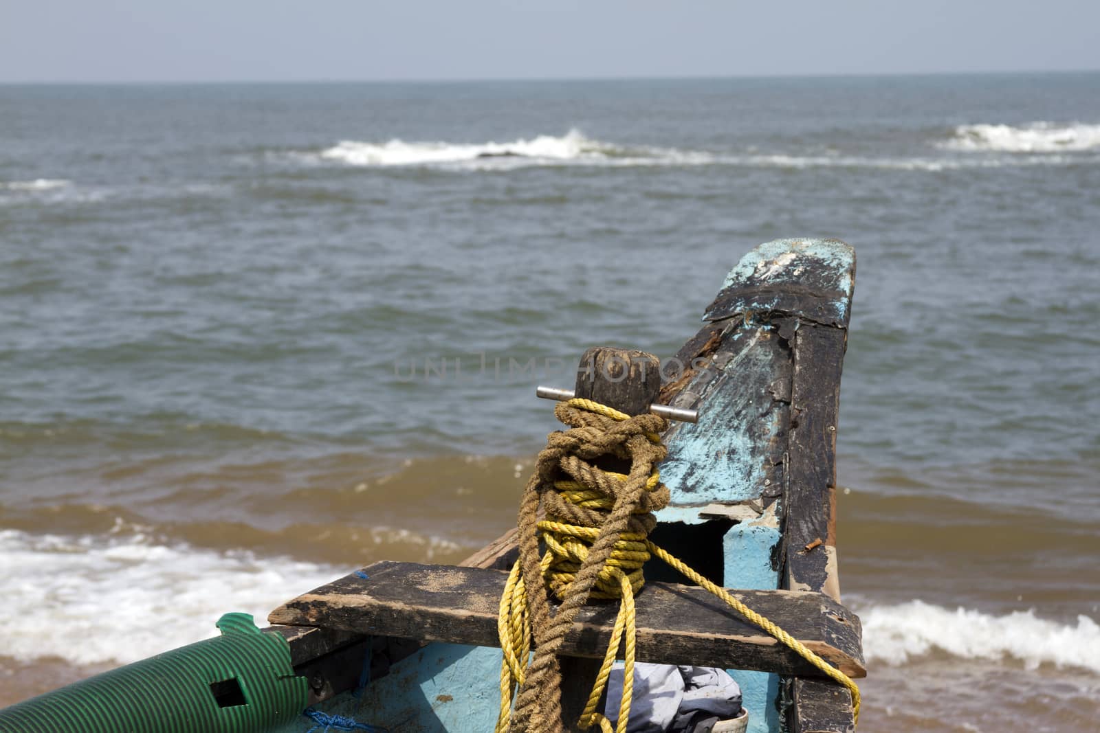 Old fishing boat standing on the sandy beach. India, Goa by mcherevan