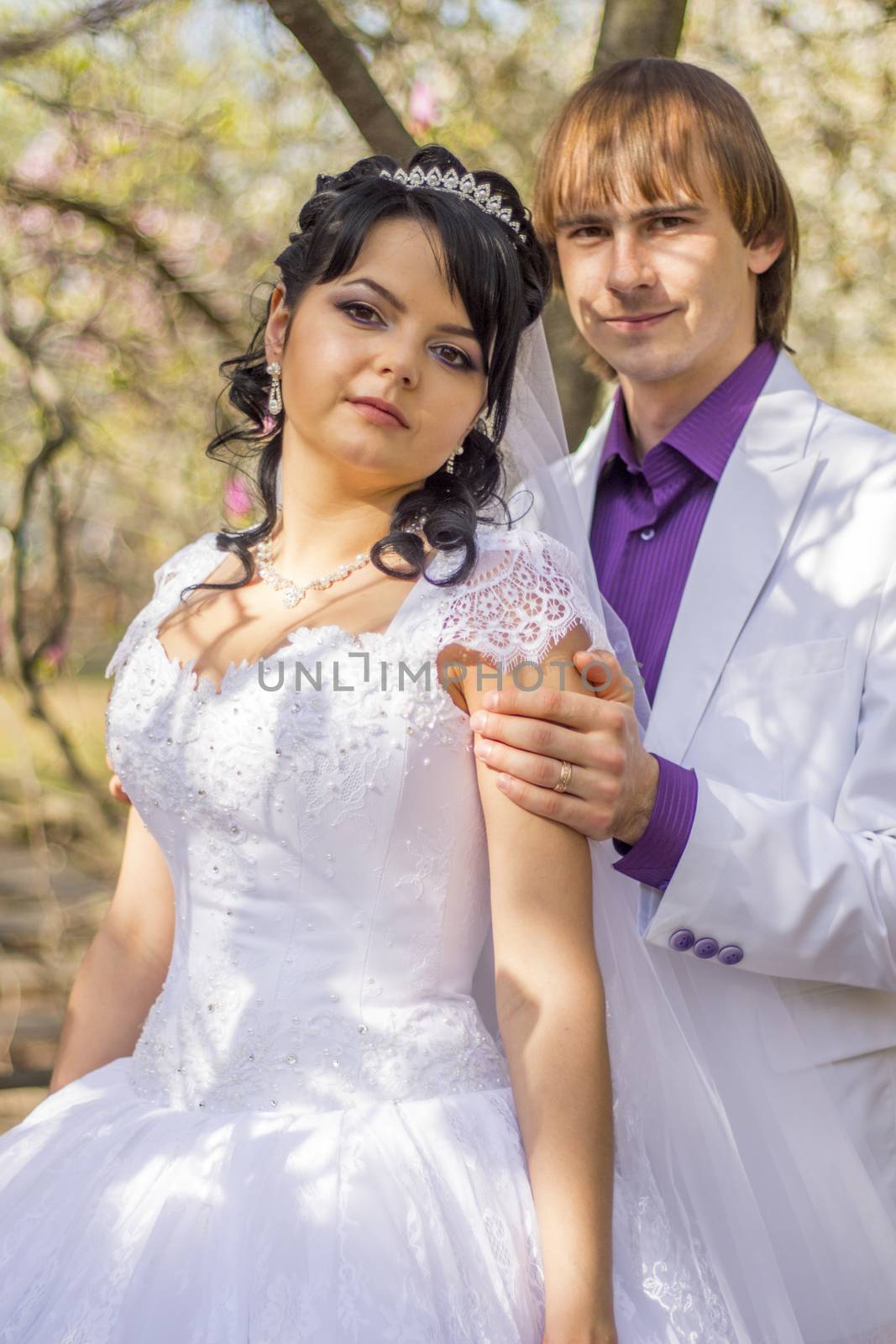 Happy young bride and groom on their wedding day by serhii_lohvyniuk