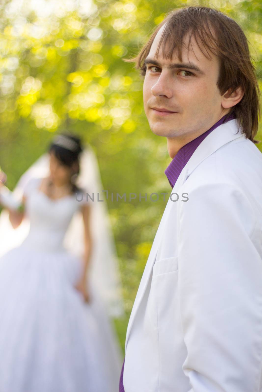 The bride and groom in the background. For your commercial and editorial use.