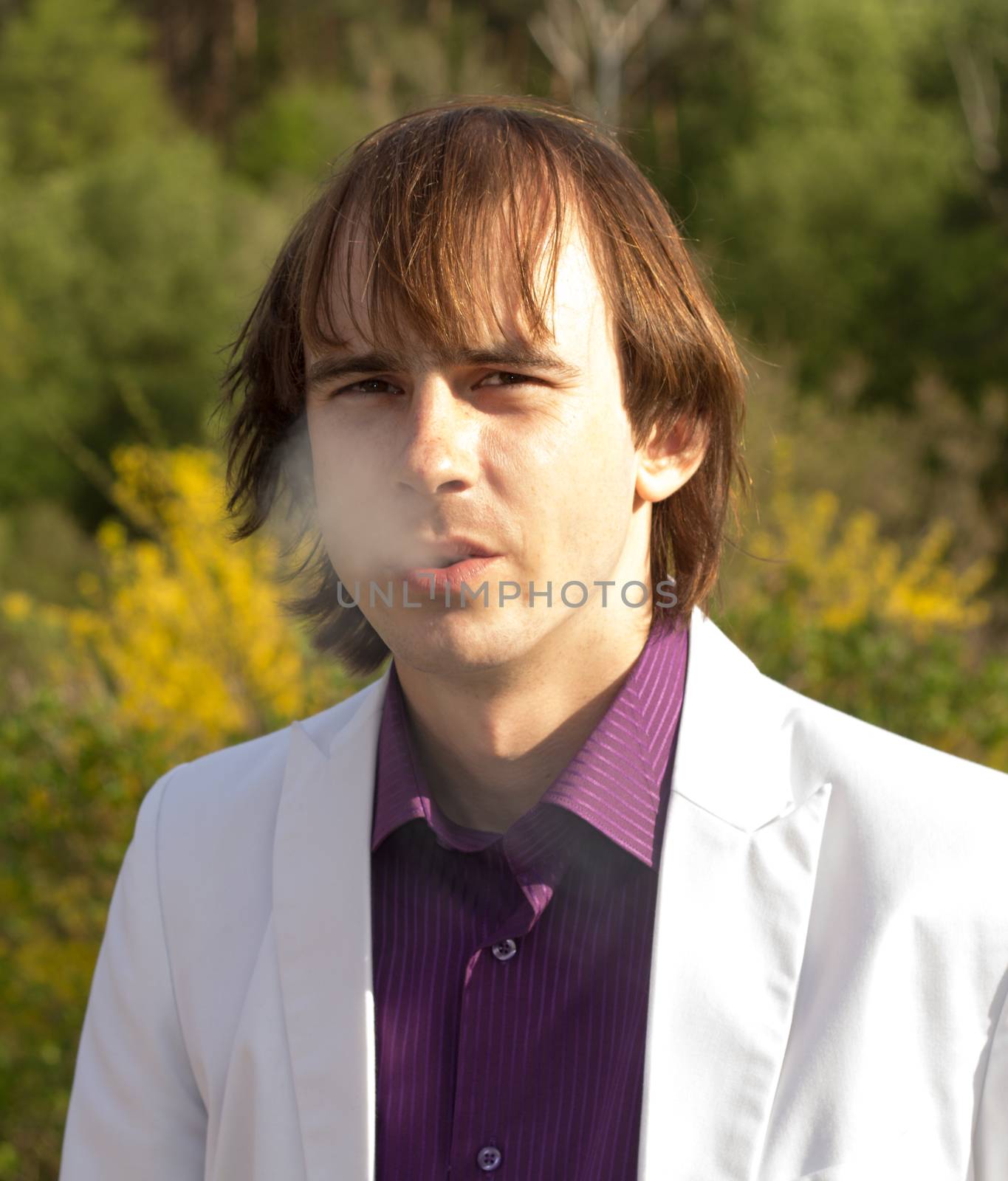Young and handsome man smoking cigarette by serhii_lohvyniuk