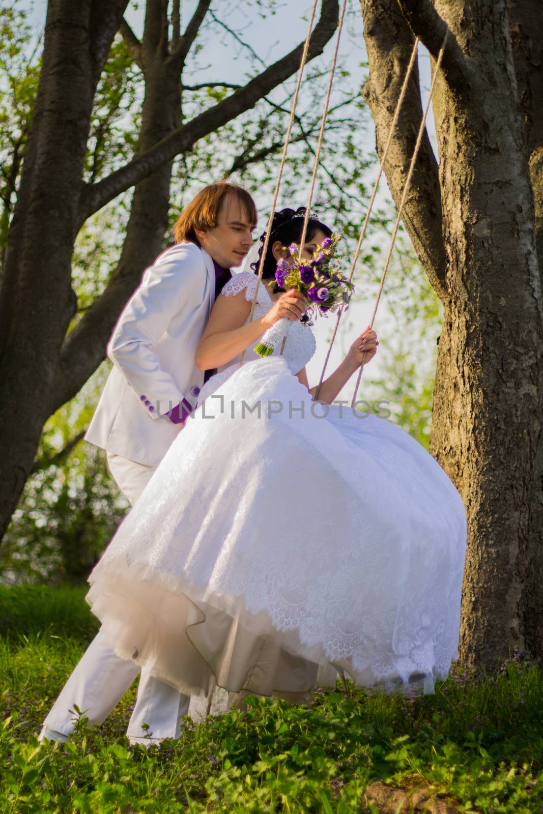 bride and groom swinging on a swing. For your commercial and editorial use.