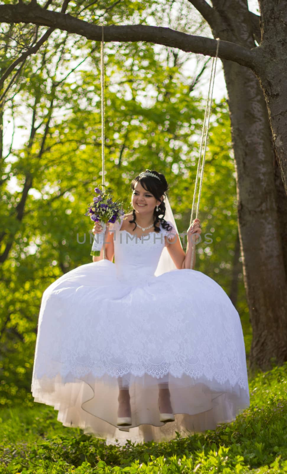 Portrait of a beautiful bride in white wedding dress sitting on  by serhii_lohvyniuk