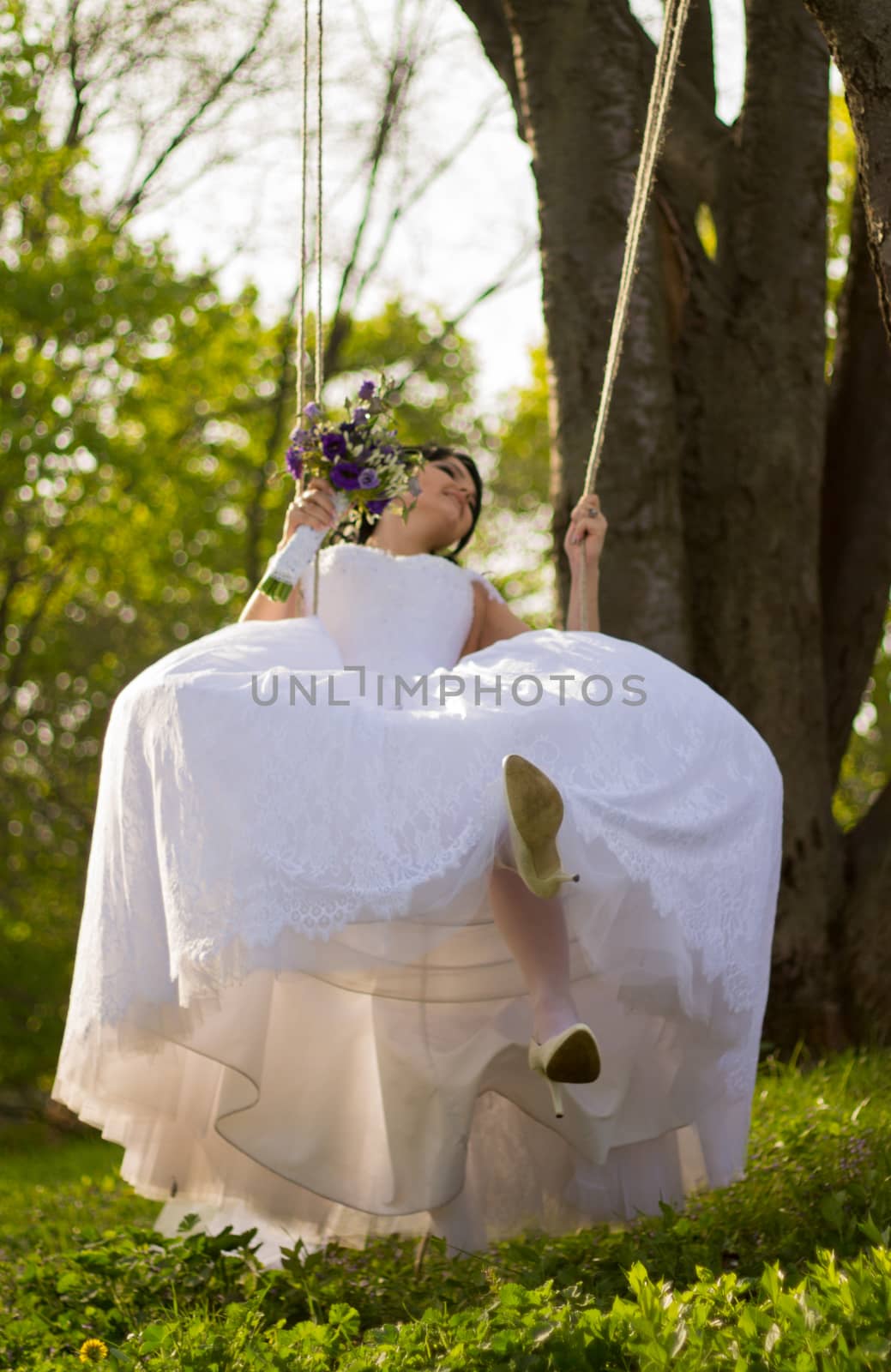 Portrait of a beautiful bride in white wedding dress sitting on  by serhii_lohvyniuk