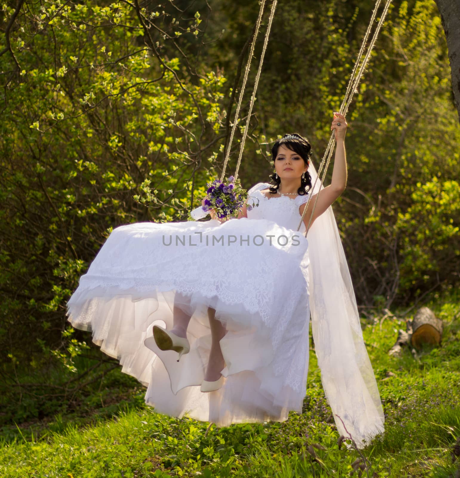 Portrait of a beautiful bride in white wedding dress sitting on  by serhii_lohvyniuk