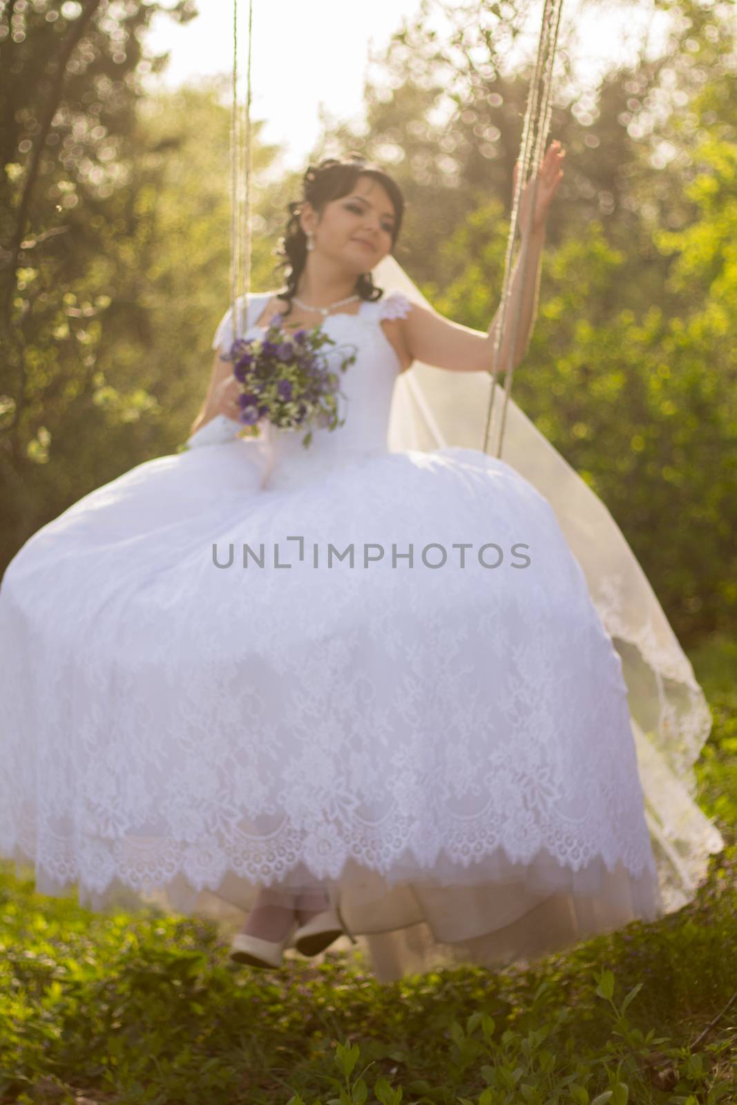 Portrait of a beautiful bride in white wedding dress sitting on  by serhii_lohvyniuk