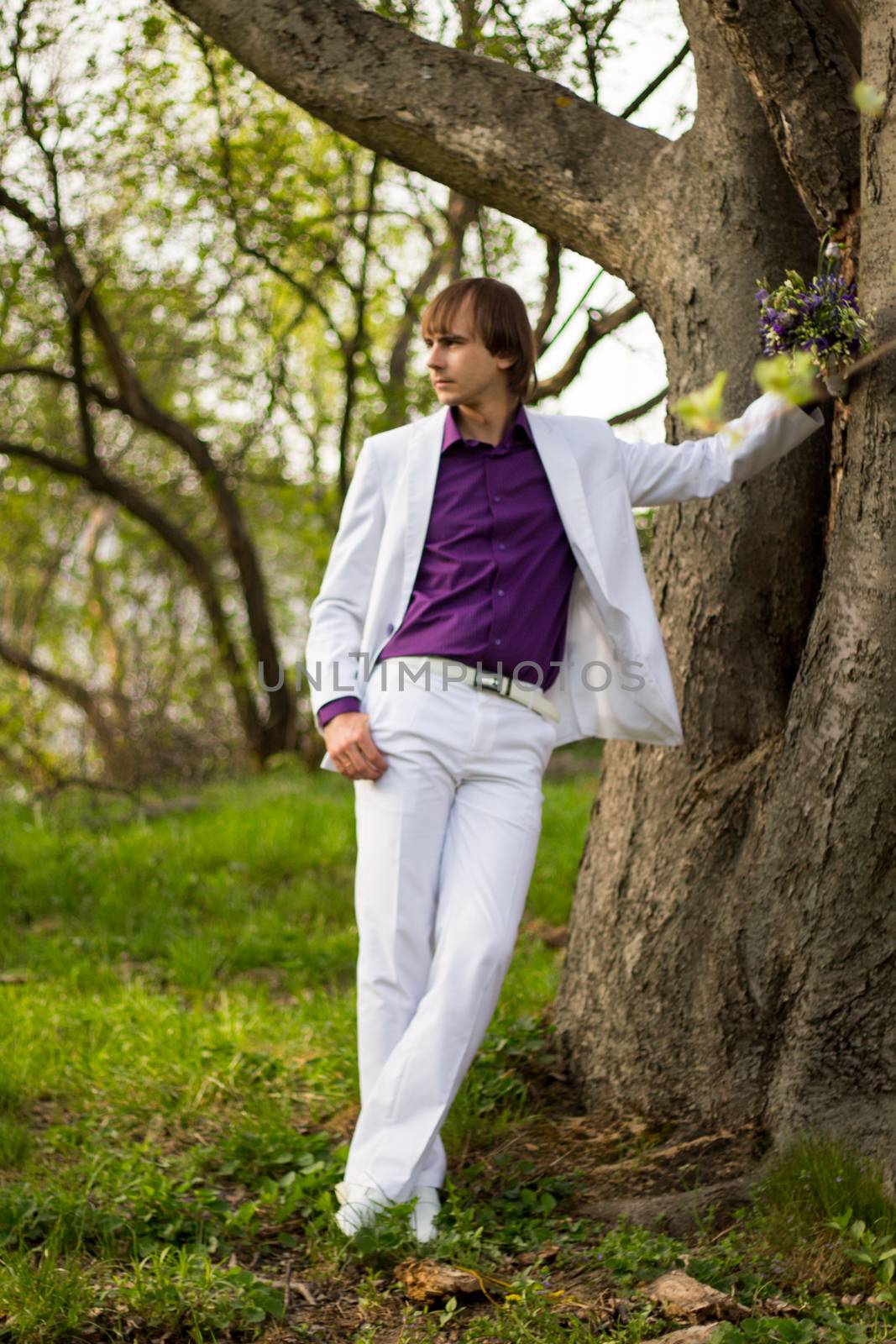 Handsome man wearing bouquet of flowers. For your commercial and editorial use.