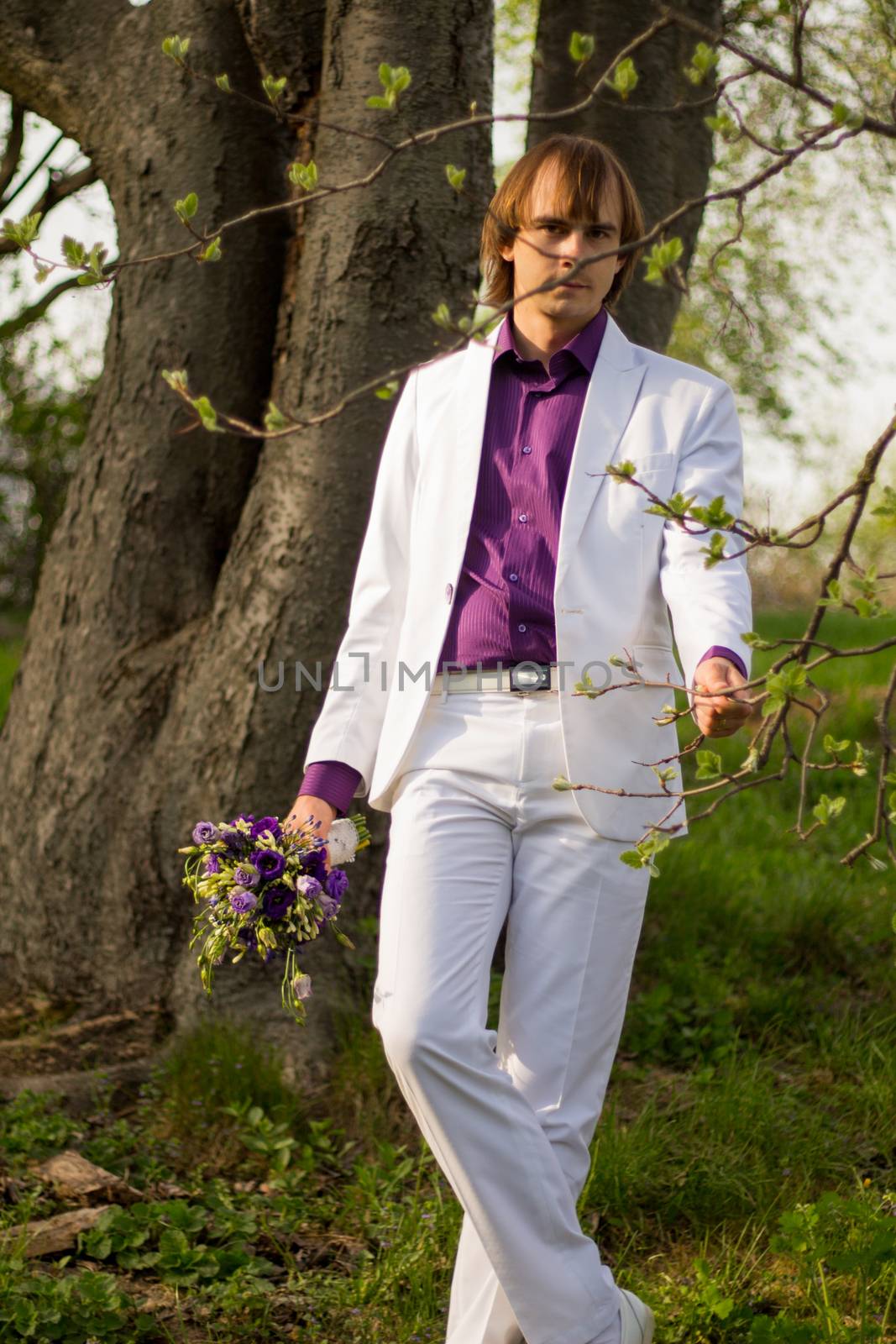 Handsome man wearing bouquet of flowers. For your commercial and editorial use.
