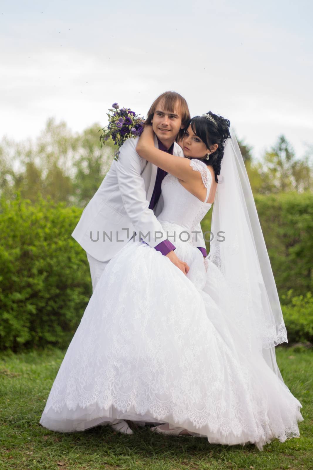 Groom and Bride a park. dress. Bridal wedding bouquet by serhii_lohvyniuk
