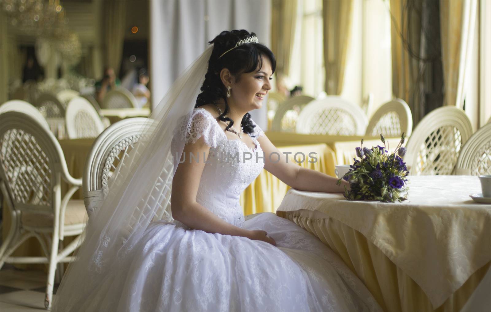 Happy young bride with wedding bouquet. For your commercial and editorial use.