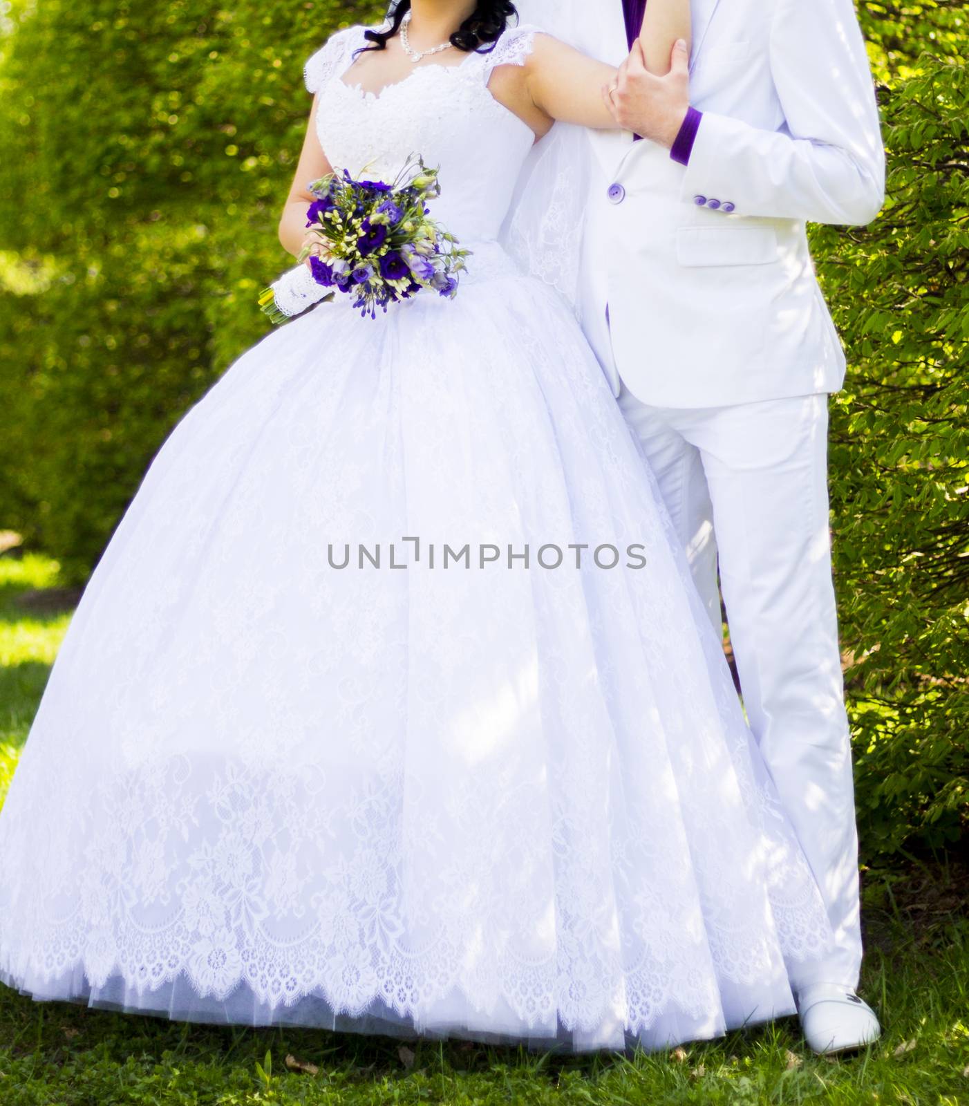 Elegant bride and groom posing together outdoors on a wedding day