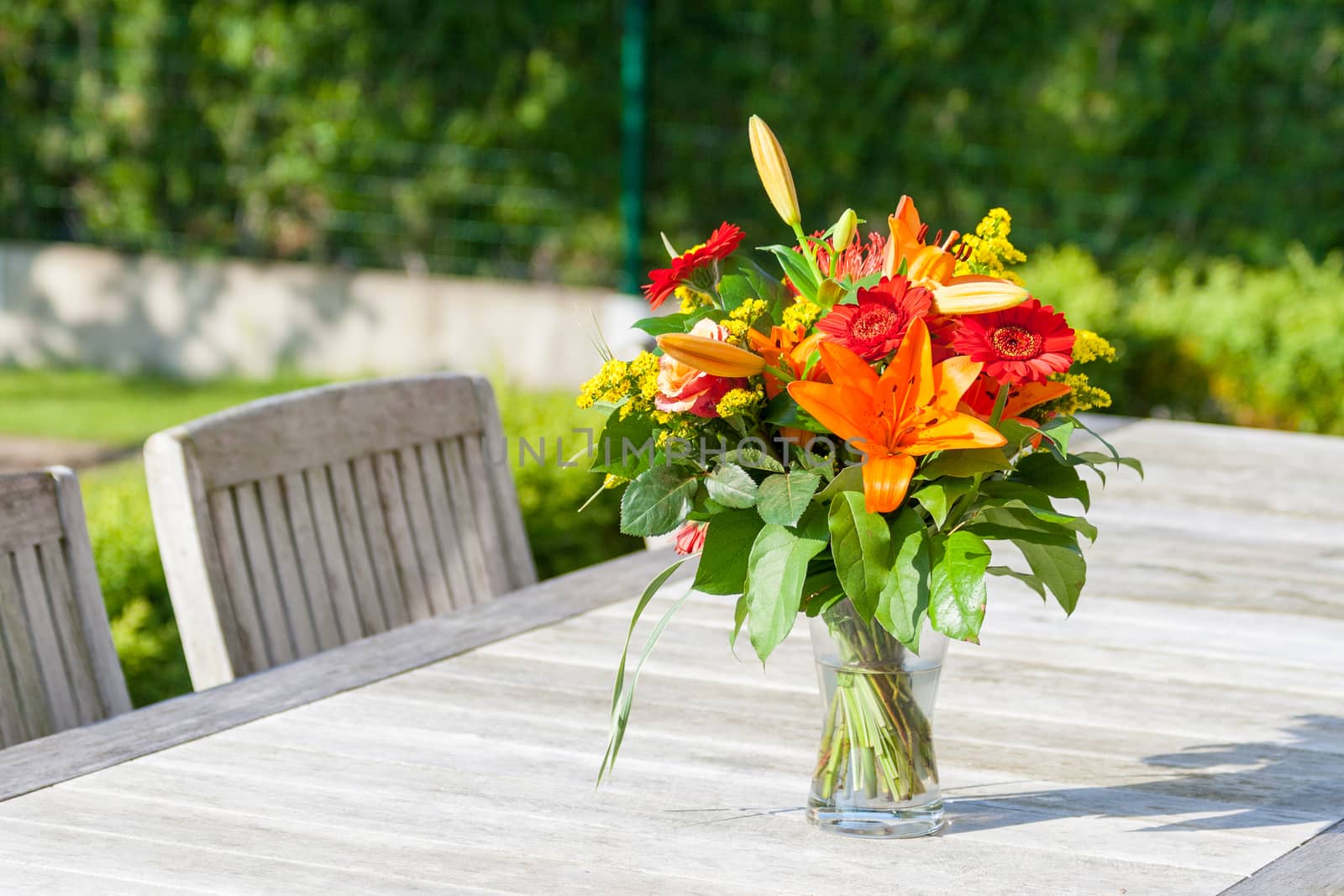 Colorful bouquet of flowers on the garden table by Havana