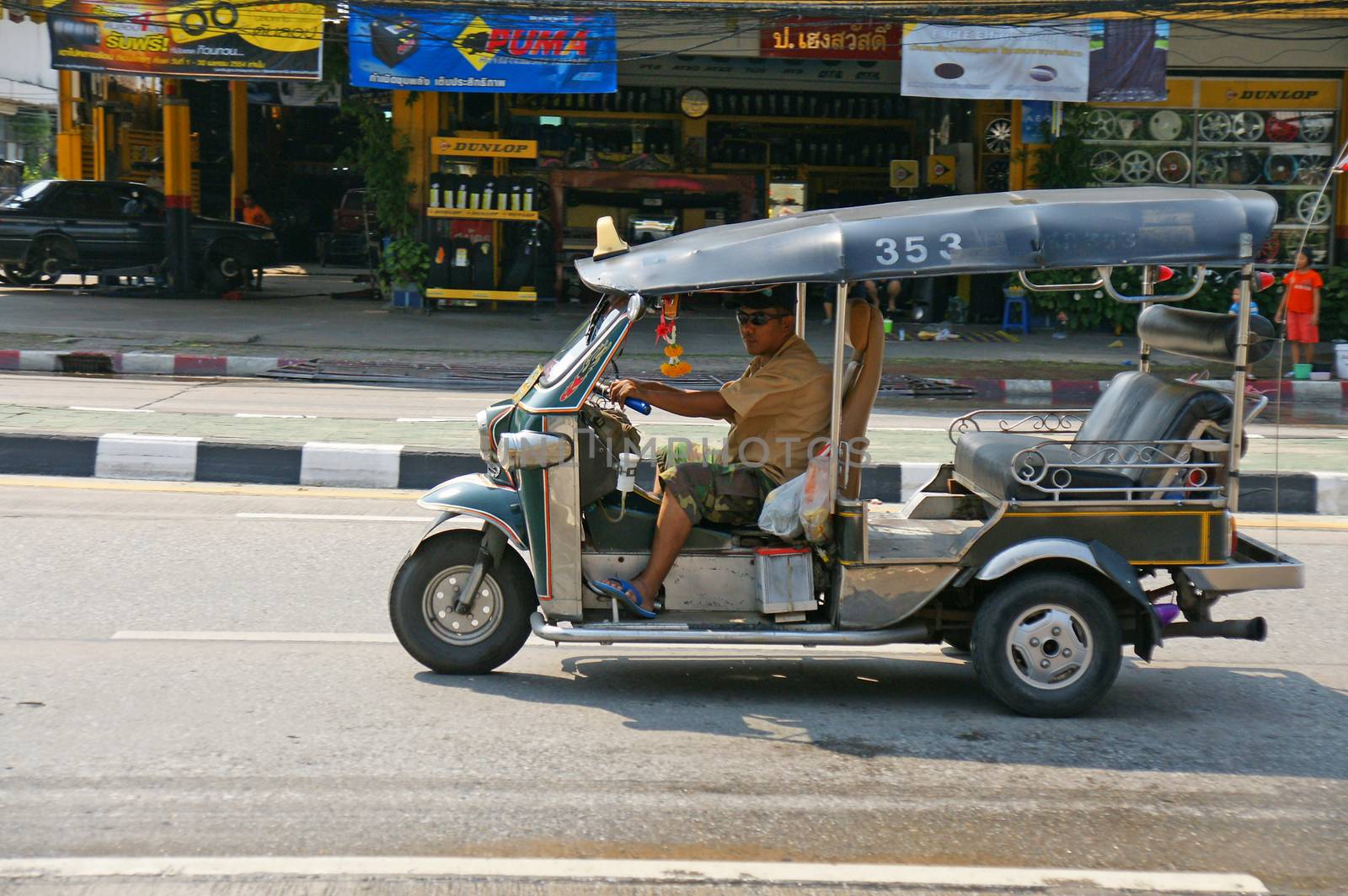 Unidentified taxi driver with traditional tuk-tuk in Thailand. by mranucha