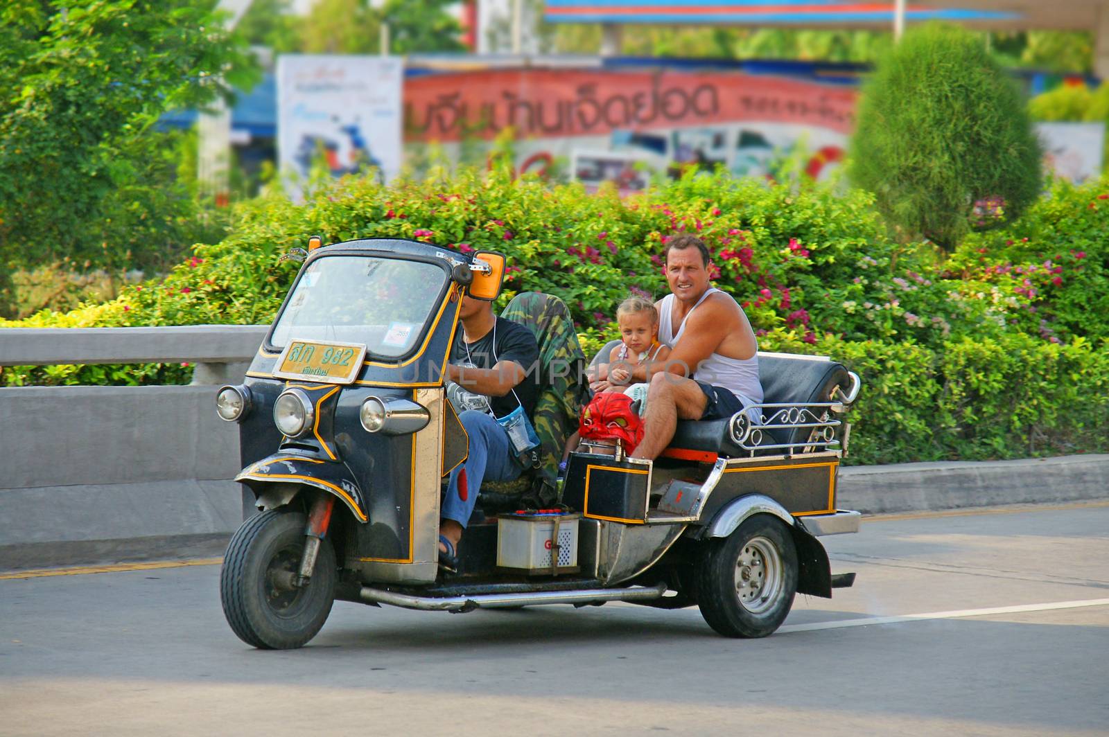Unidentified tourist with traditional tuk-tuk in Thailand. by mranucha