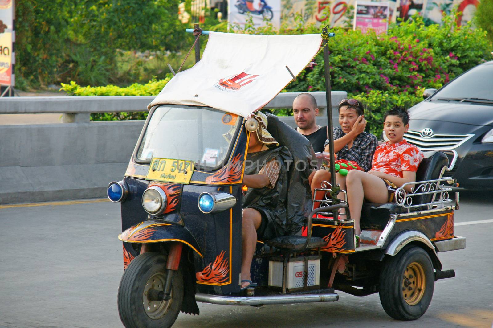 Unidentified tourist with traditional tuk-tuk in Thailand. by mranucha