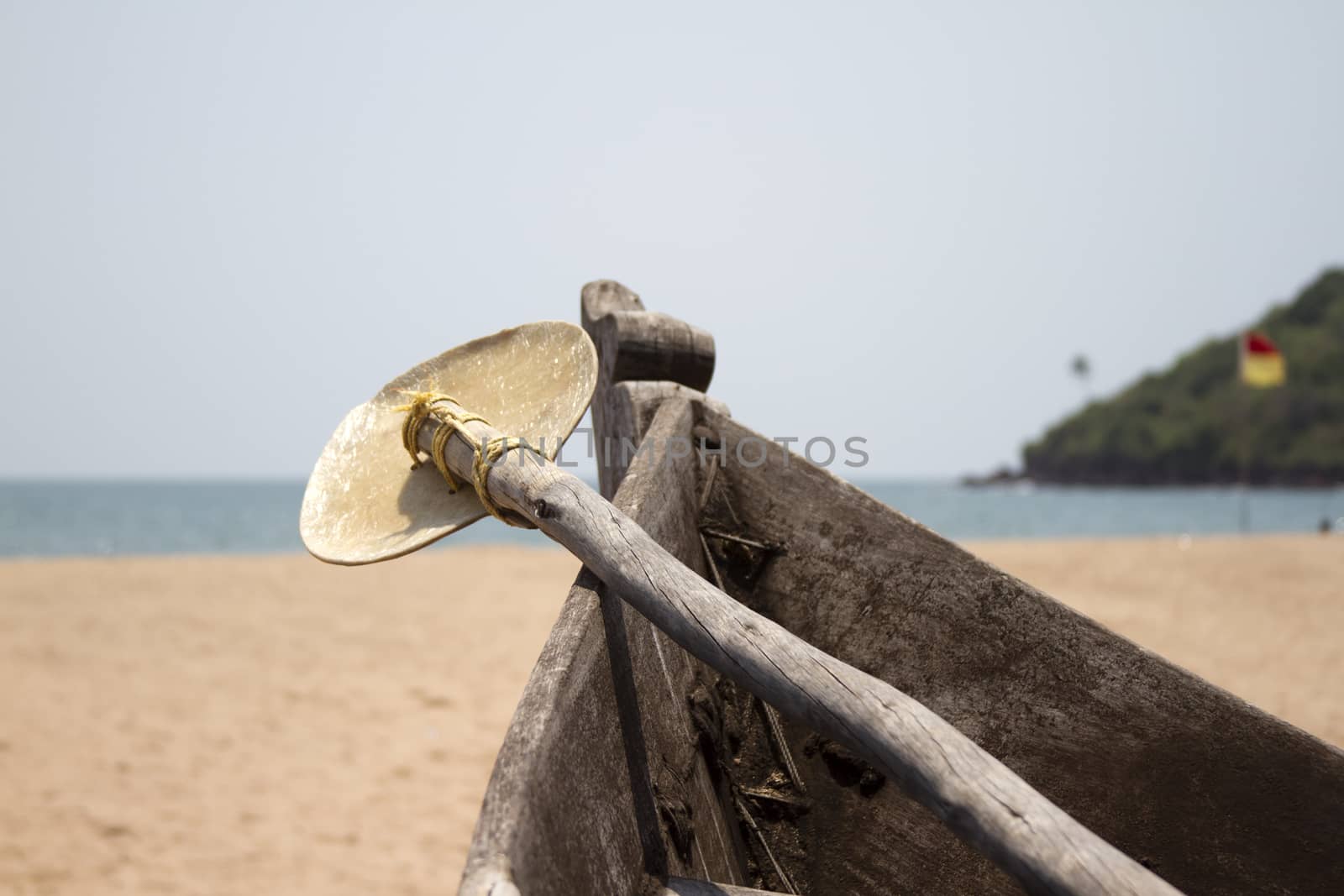 Old fishing boat standing on the sandy beach. India, Goa.