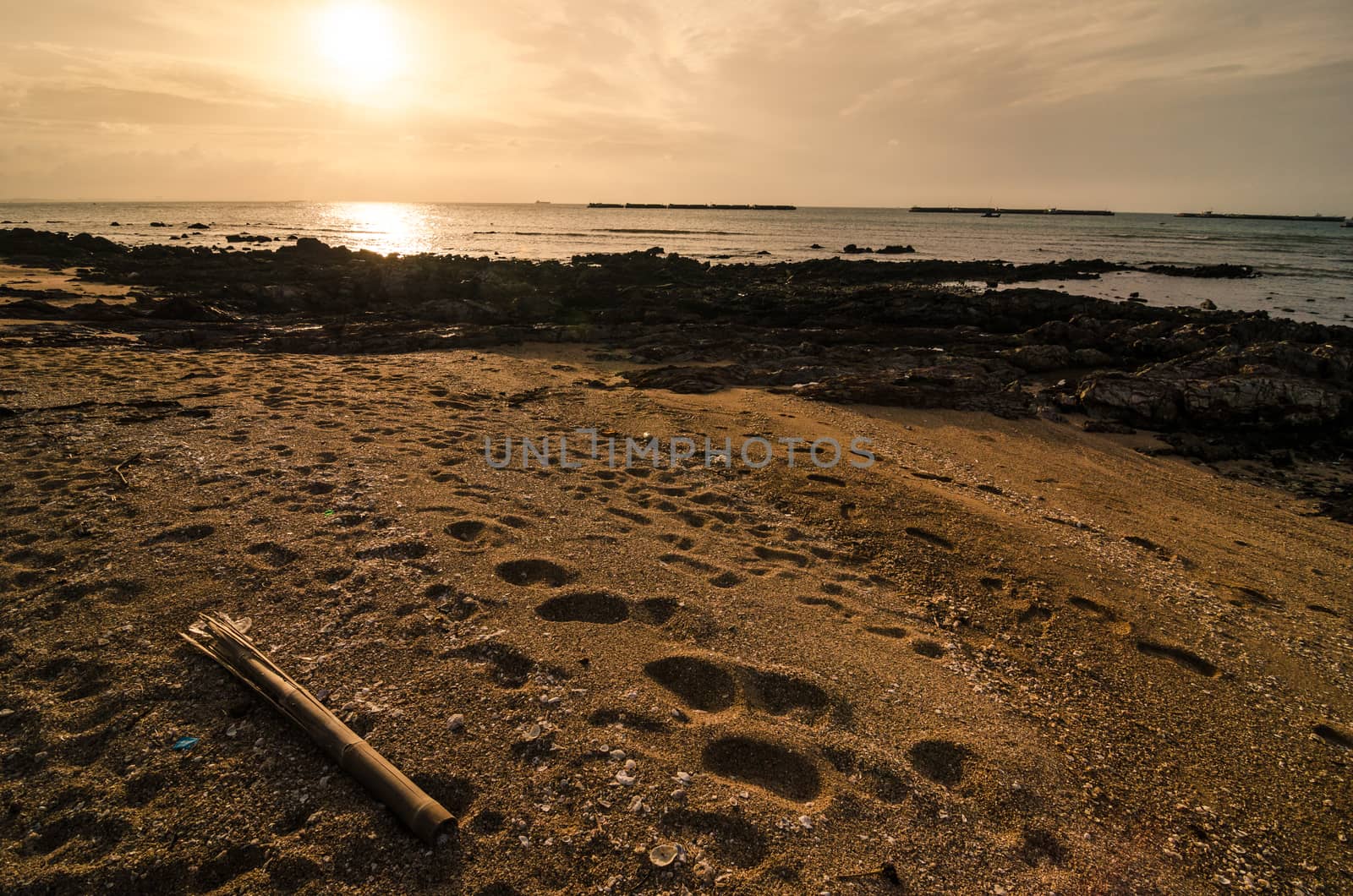 footprints and sea morning  light in Thailand