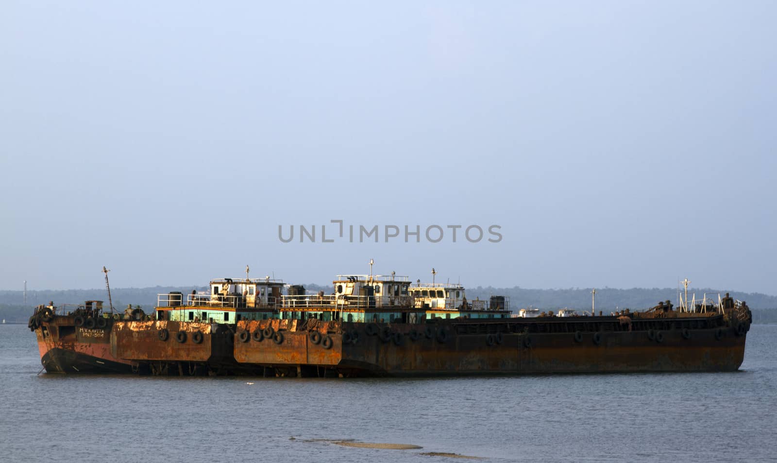 The parking of the old cargo ships stand. Cemetery of the old ships India, Goa by mcherevan