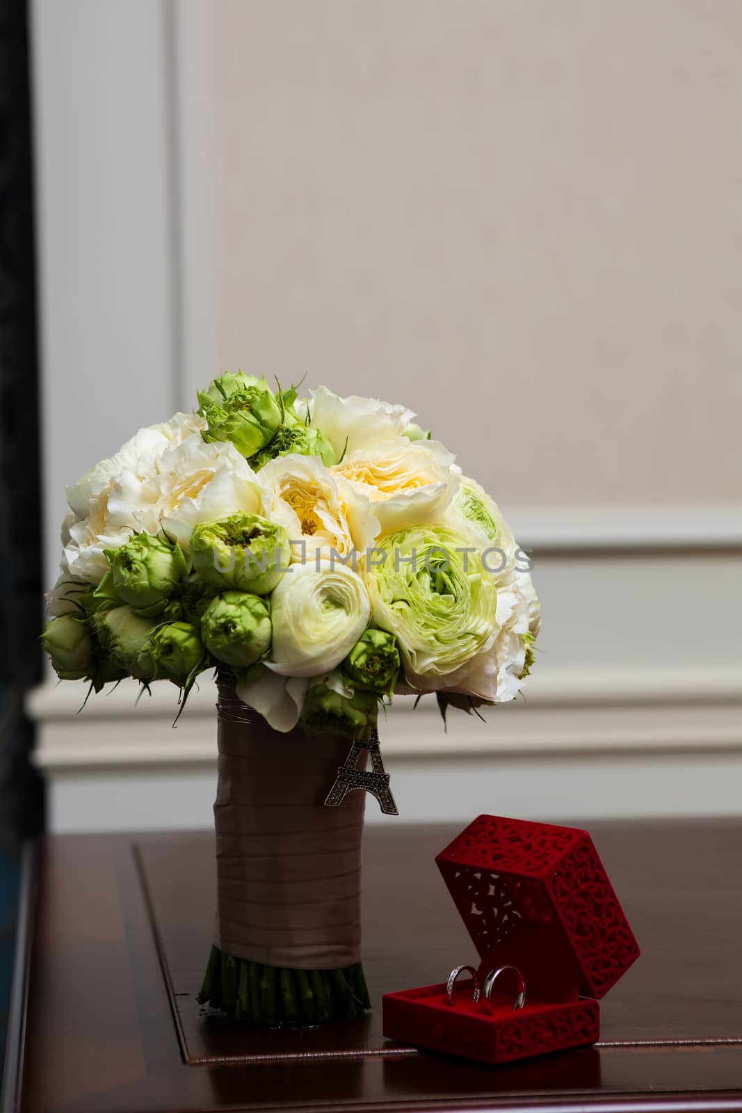 Bouquet of white roses and silver wedding rings