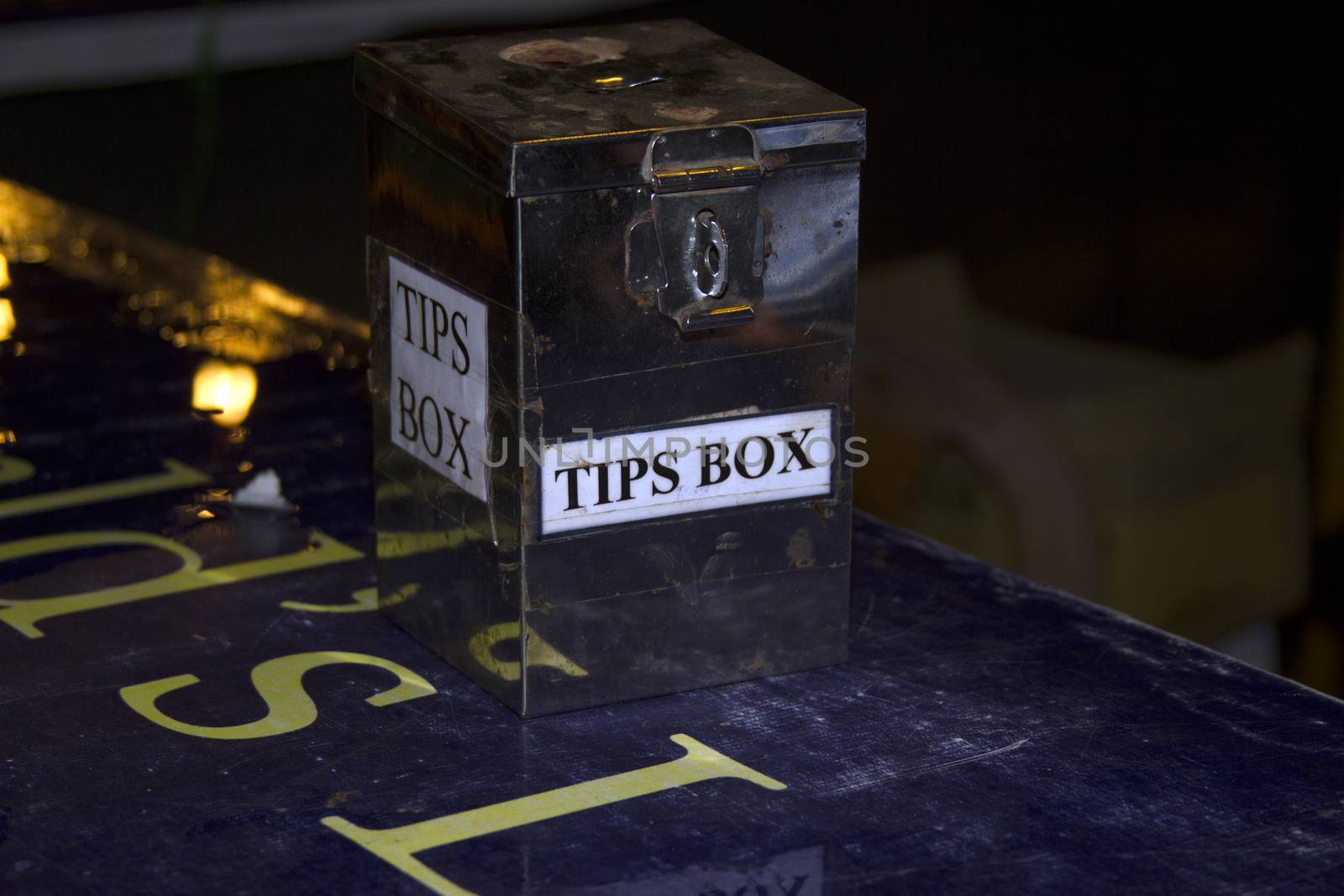 Tip Box Metal boxes for a trifle on a bar counter.