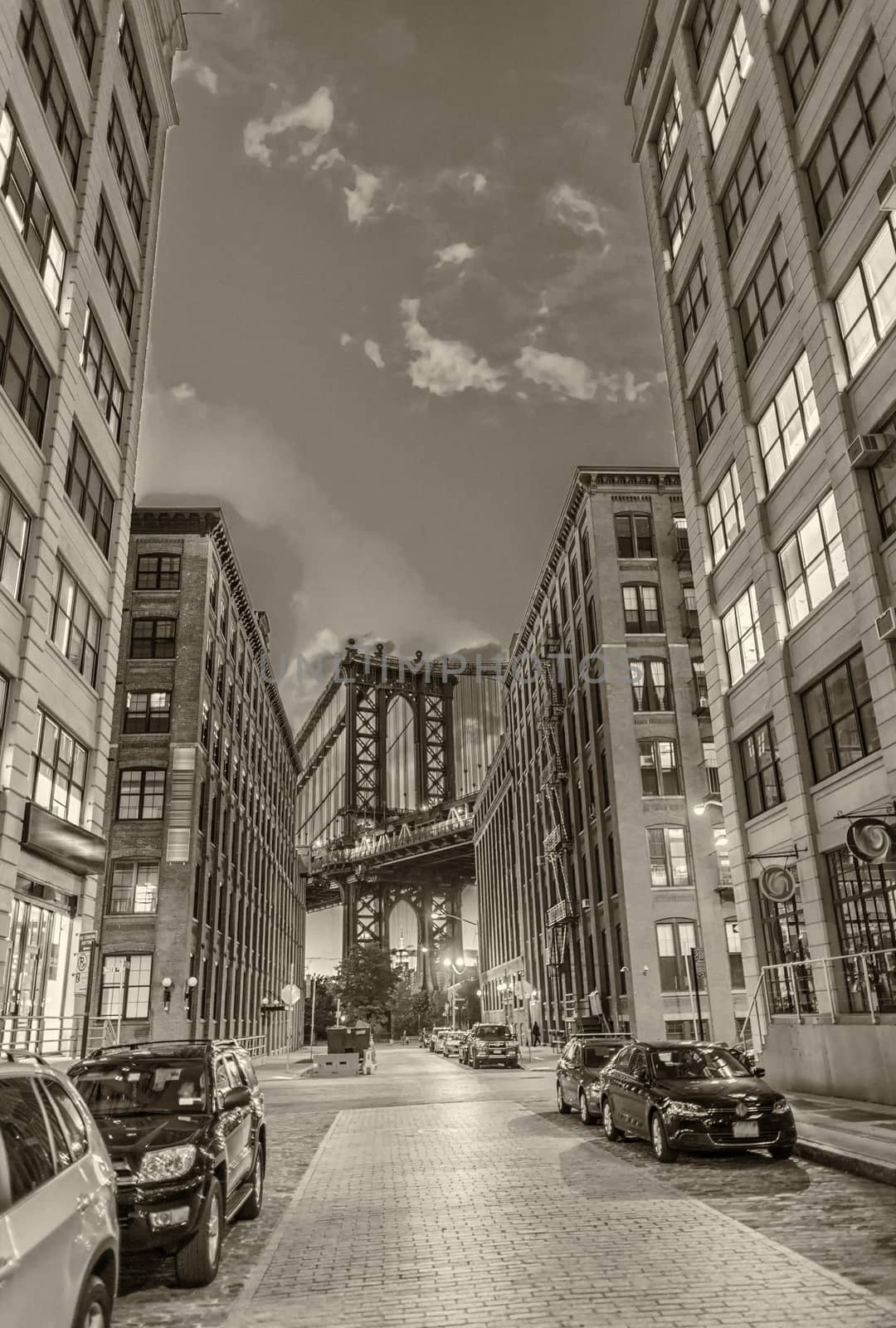 The Manhattan Bridge framed at night by Brooklyn buildings by jovannig