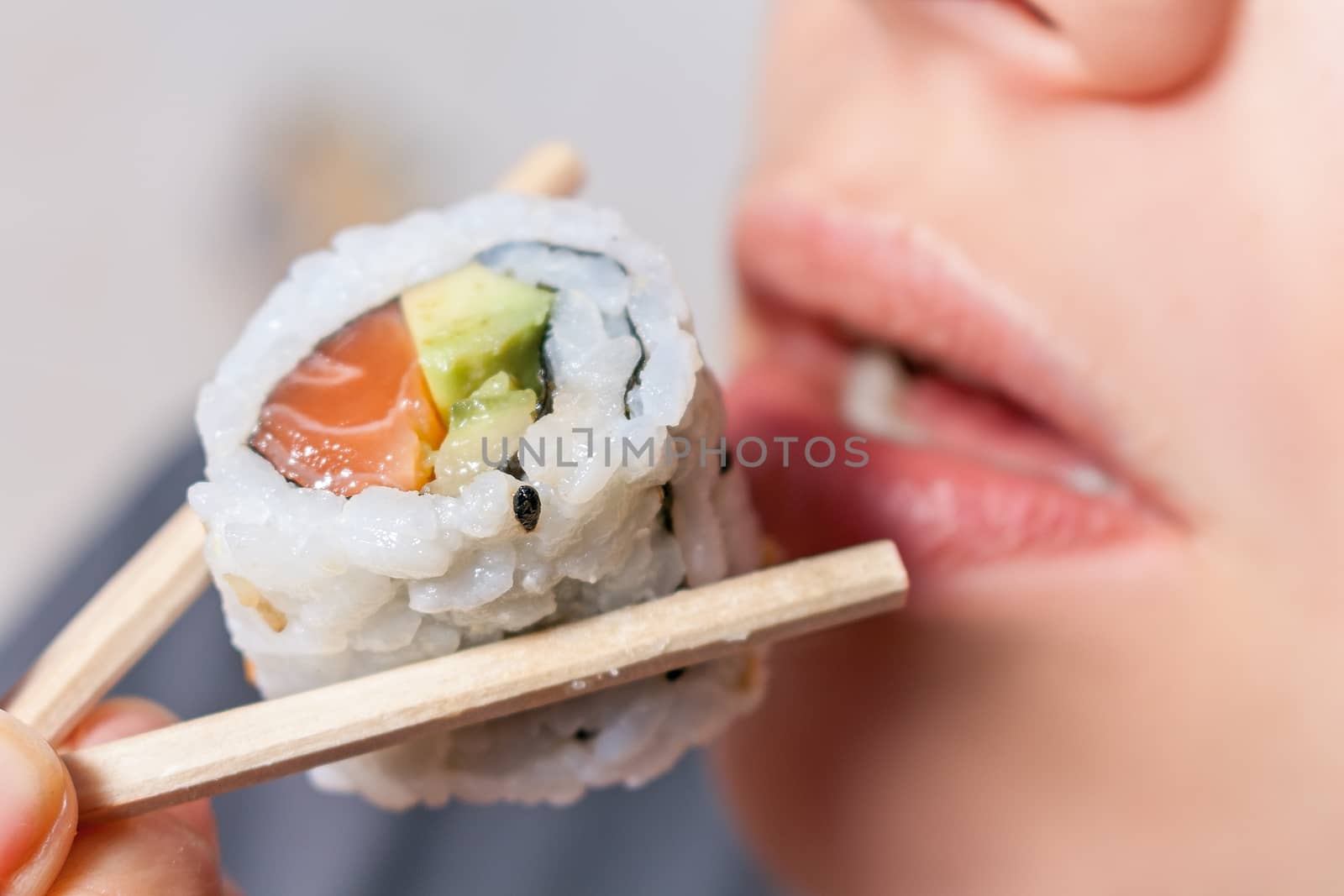 Close-up shot of a person who eats sushi