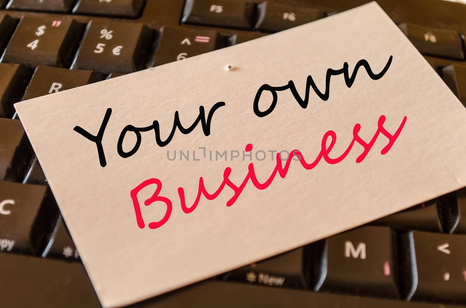 Your own business Concept on black keyboard