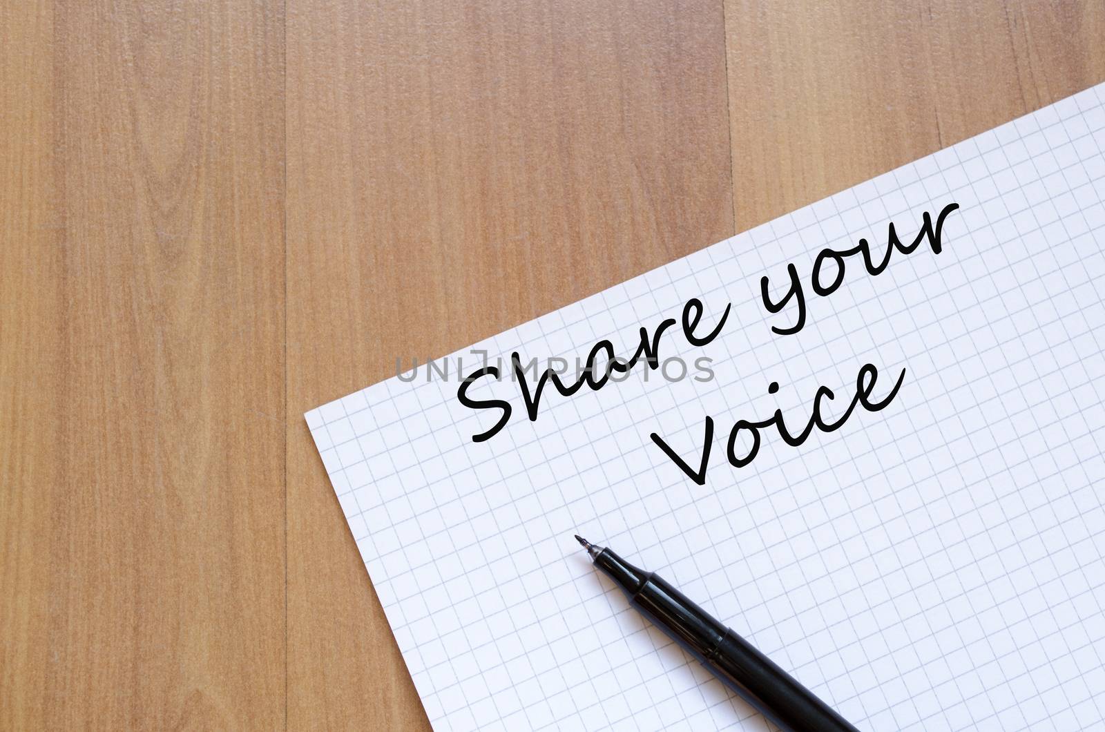 White blank notepad on office wooden table Share your voice concept