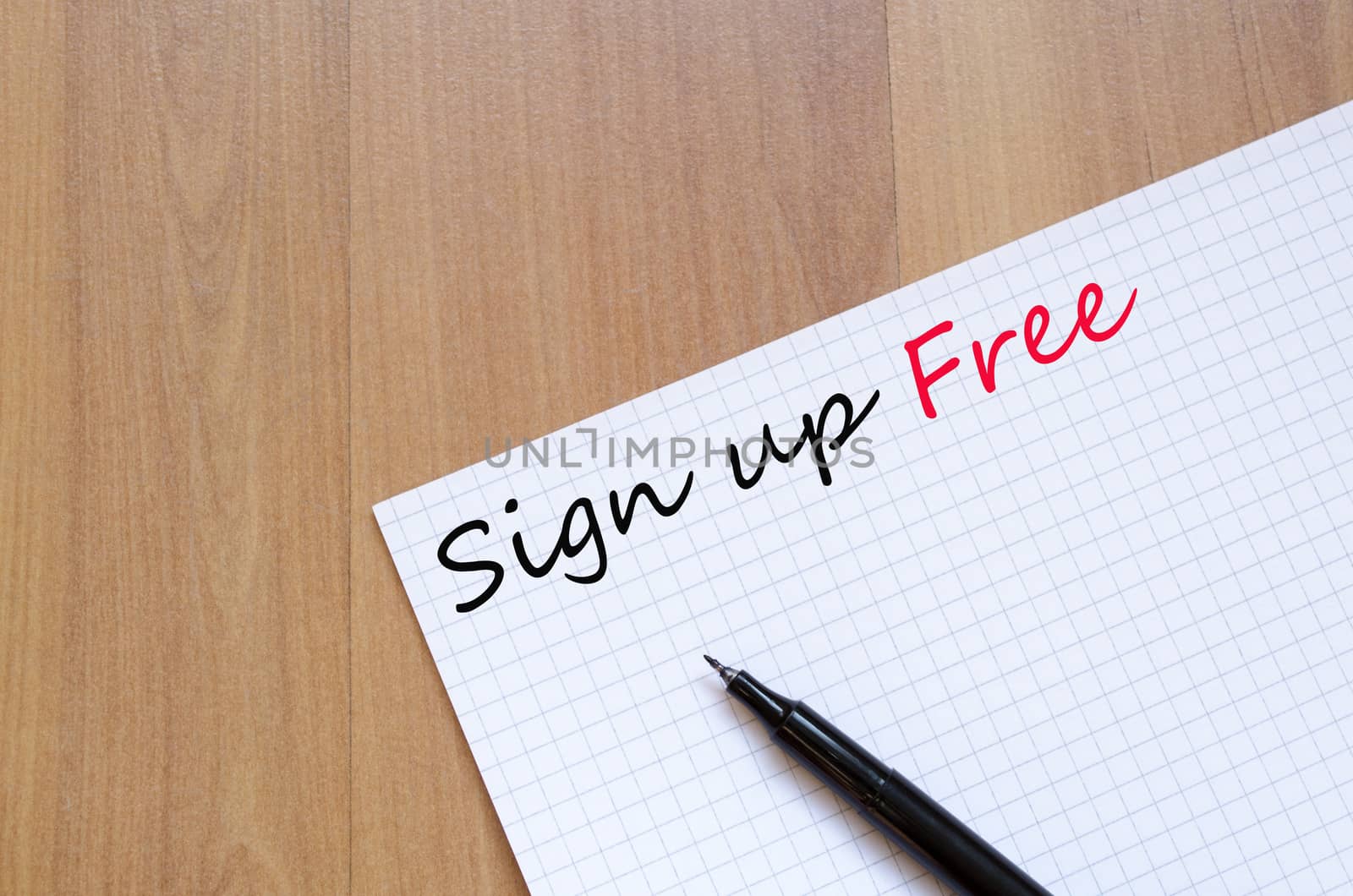White blank notepad on office wooden table Sign up free concept