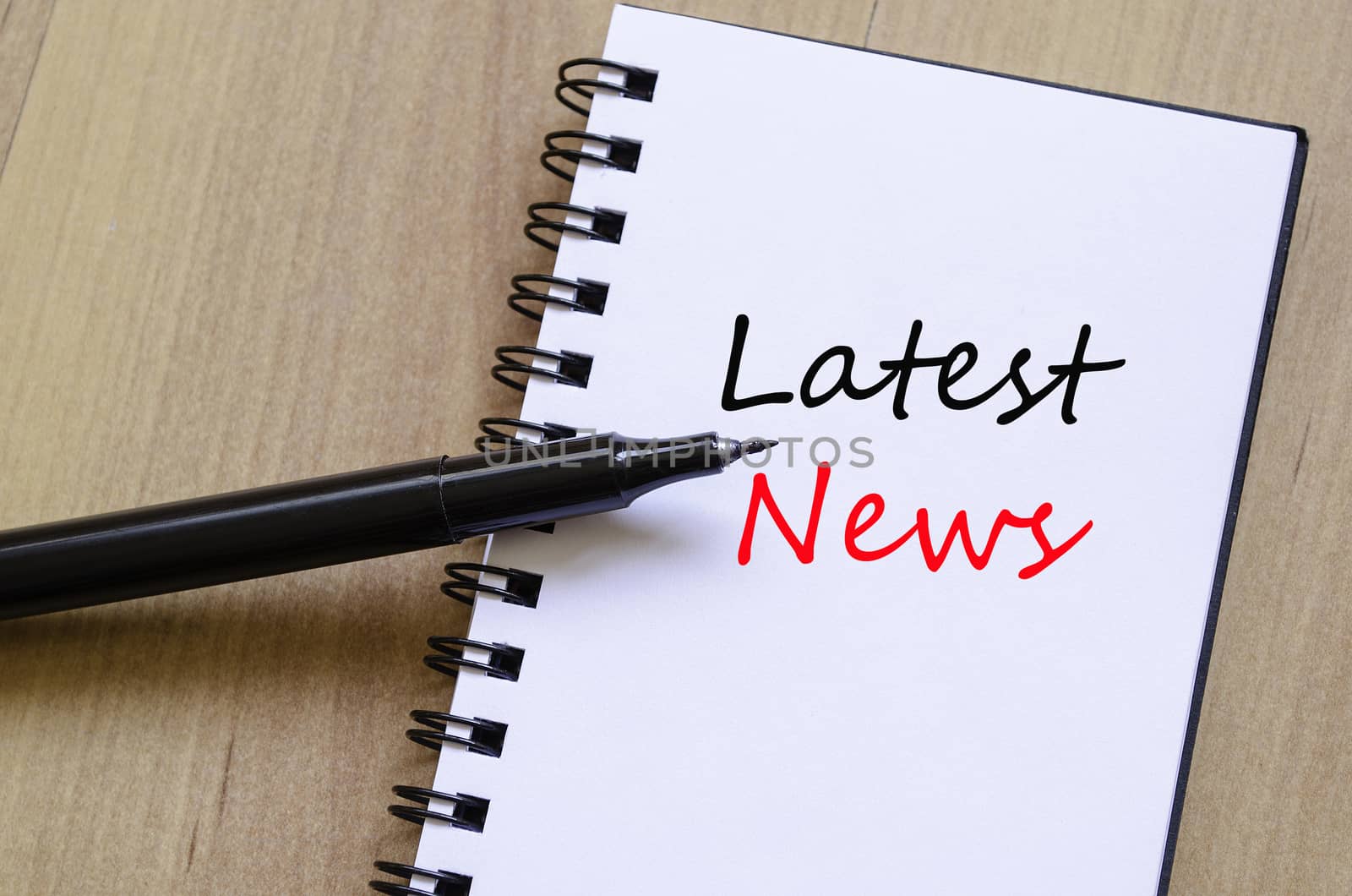 White notepad and ink pen on the wooden desk Latest News Concept