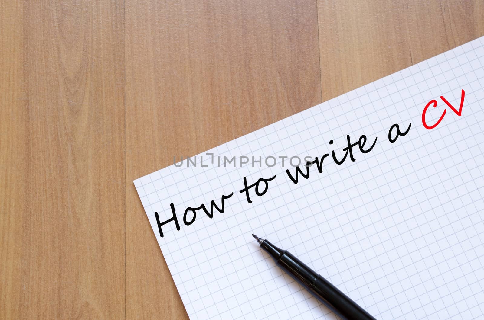 White blank notepad on office wooden table How to write a cv concept