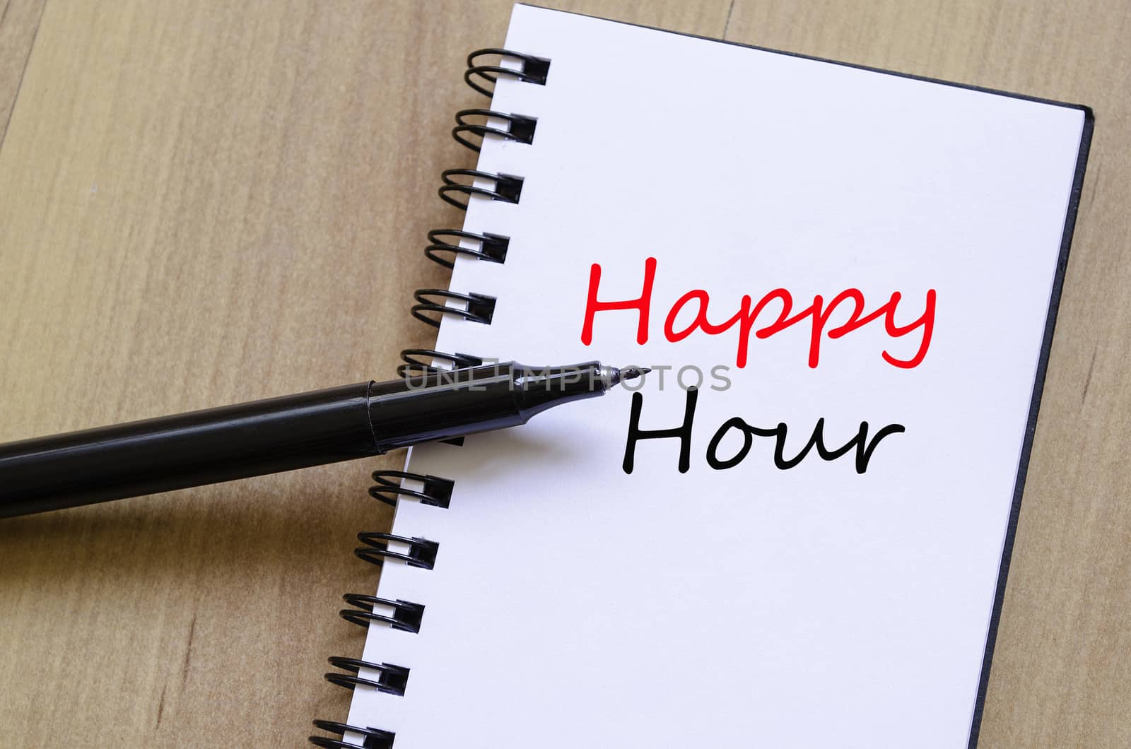 White notepad and ink pen on the wooden desk Happy Hour Concept