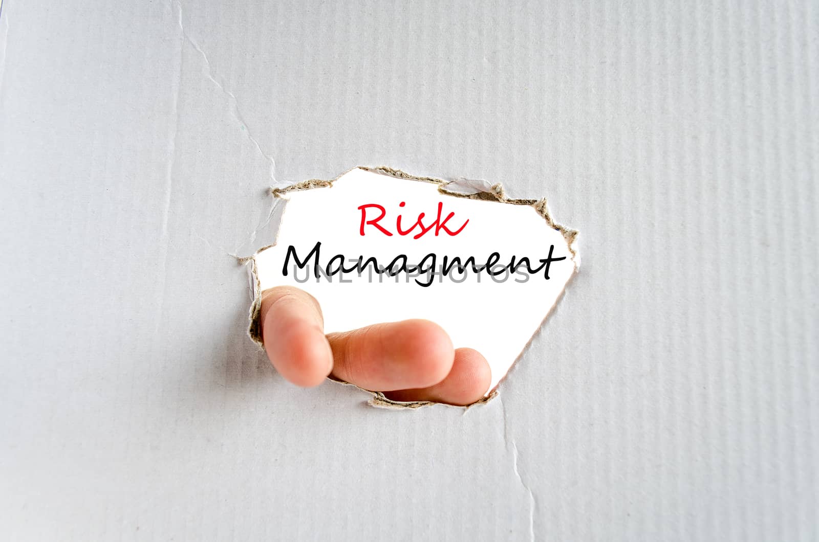Hand and text on the cardboard background Risk managment Concept