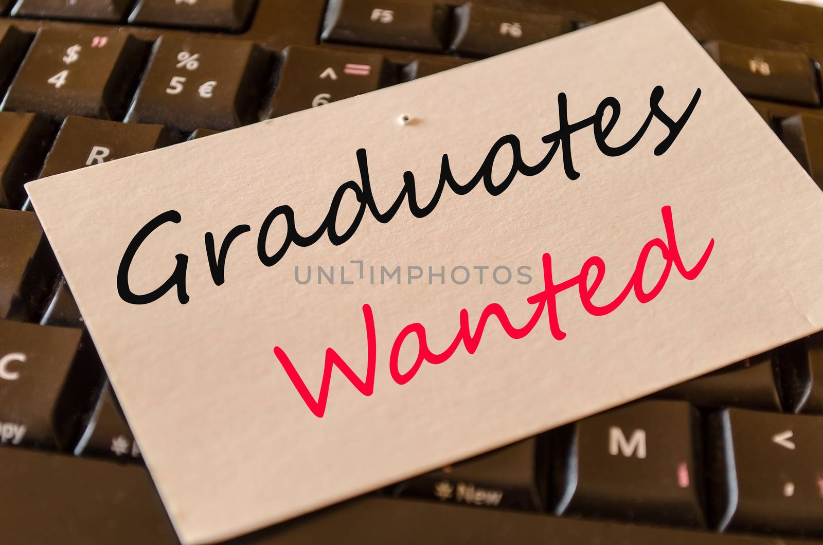 Graduates wanted Concept on black keyboard