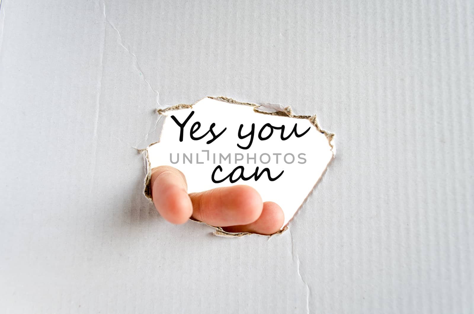 Hand and text on the cardboard background Yes you can Concept