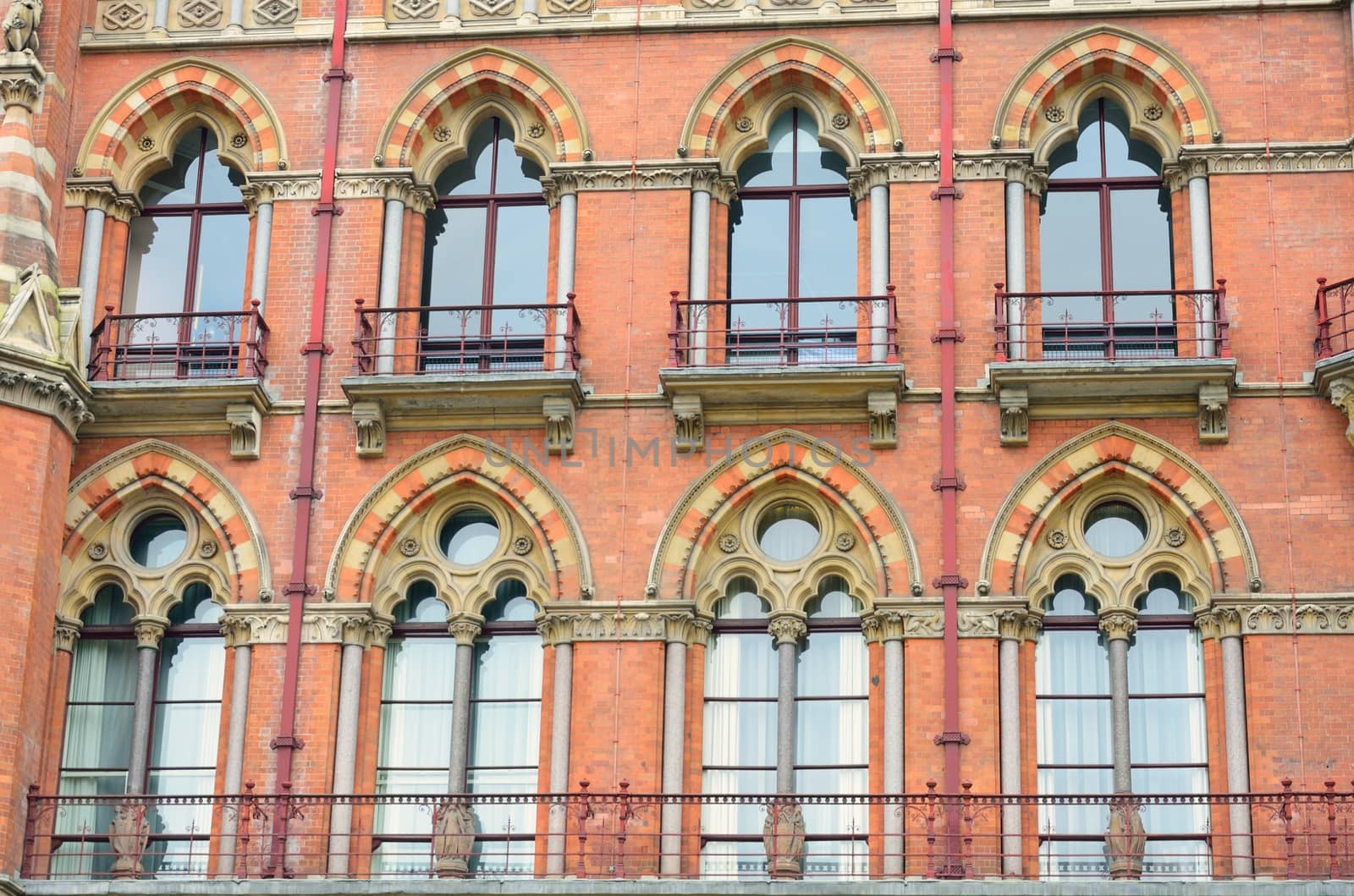 Large group of red brick vicorian windows by pauws99