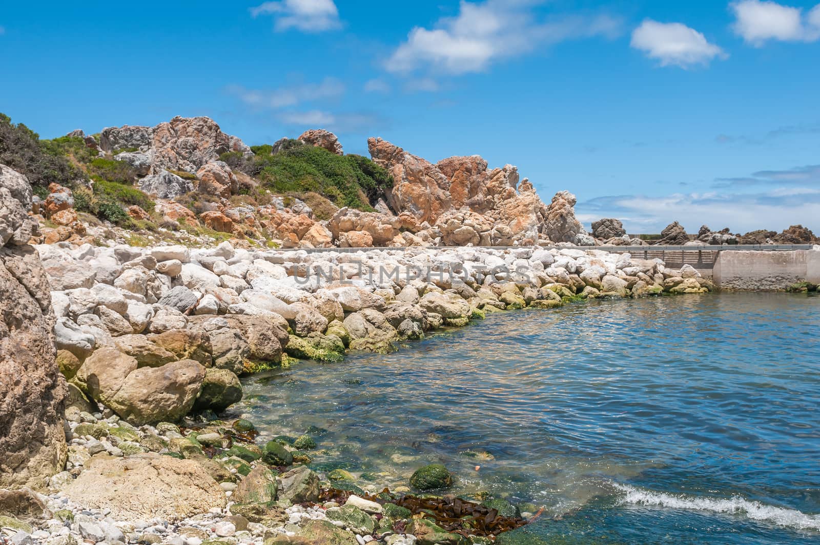 Multi-colored rocks and sea wall at the harbor in Kleinmond