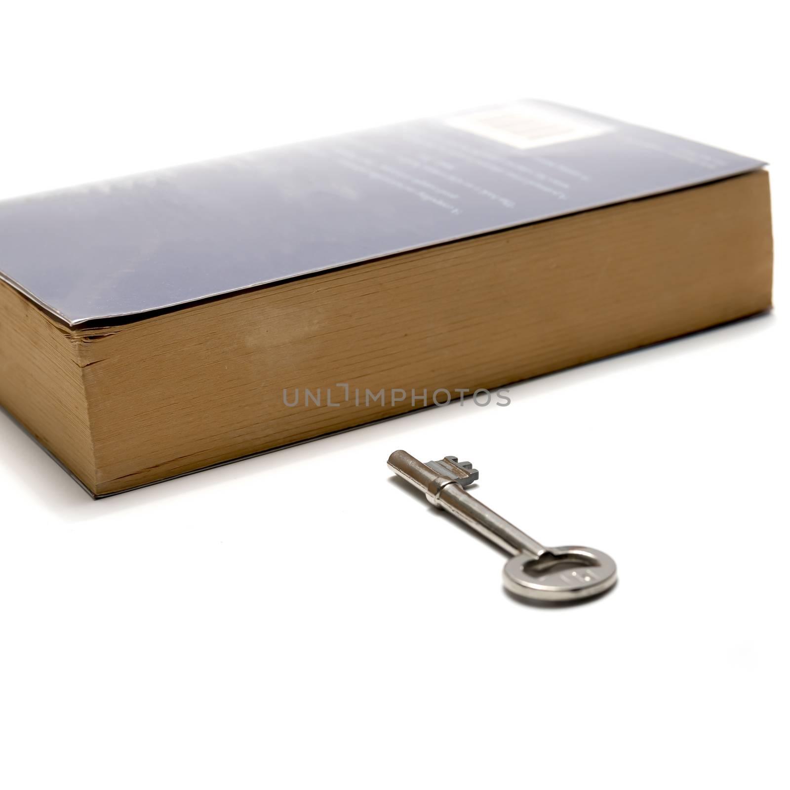 book and key isolated on white background