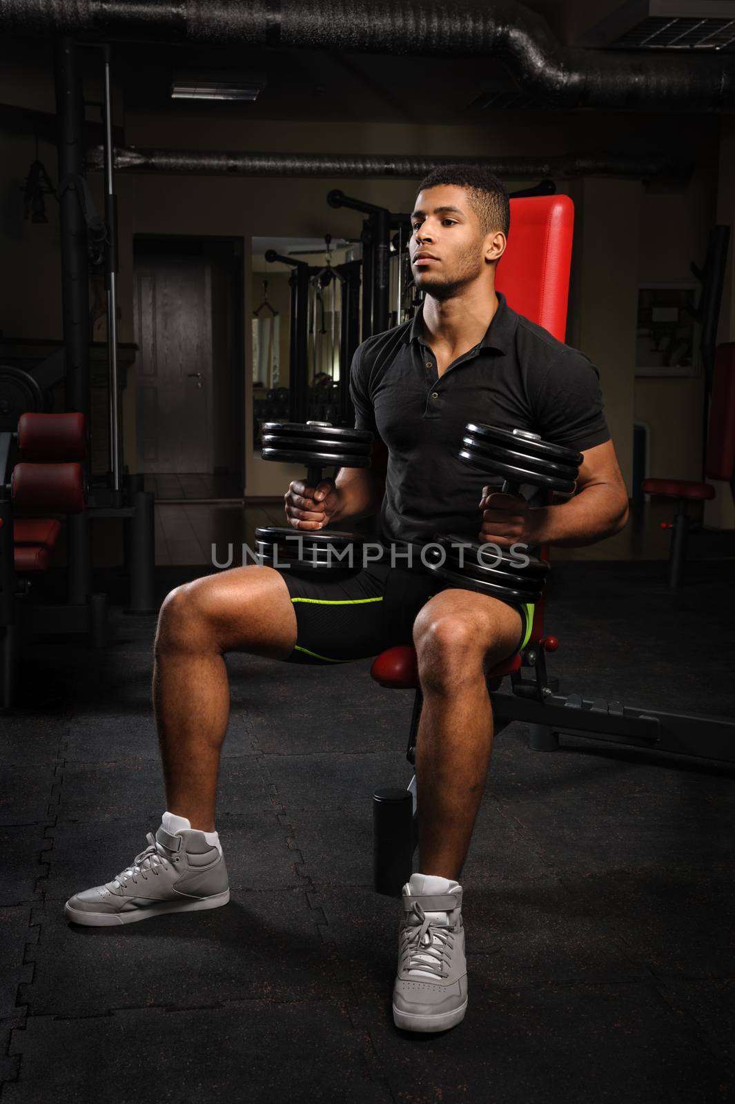 young man sitting on bench at gym by starush