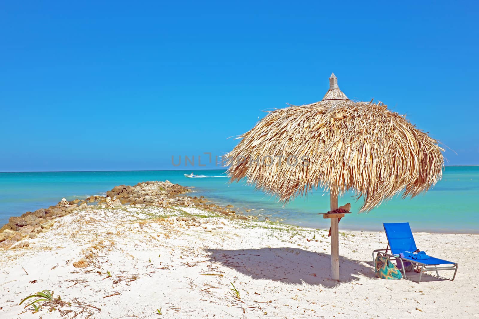 Grass umbrella at the beach on Aruba in the Caribbean