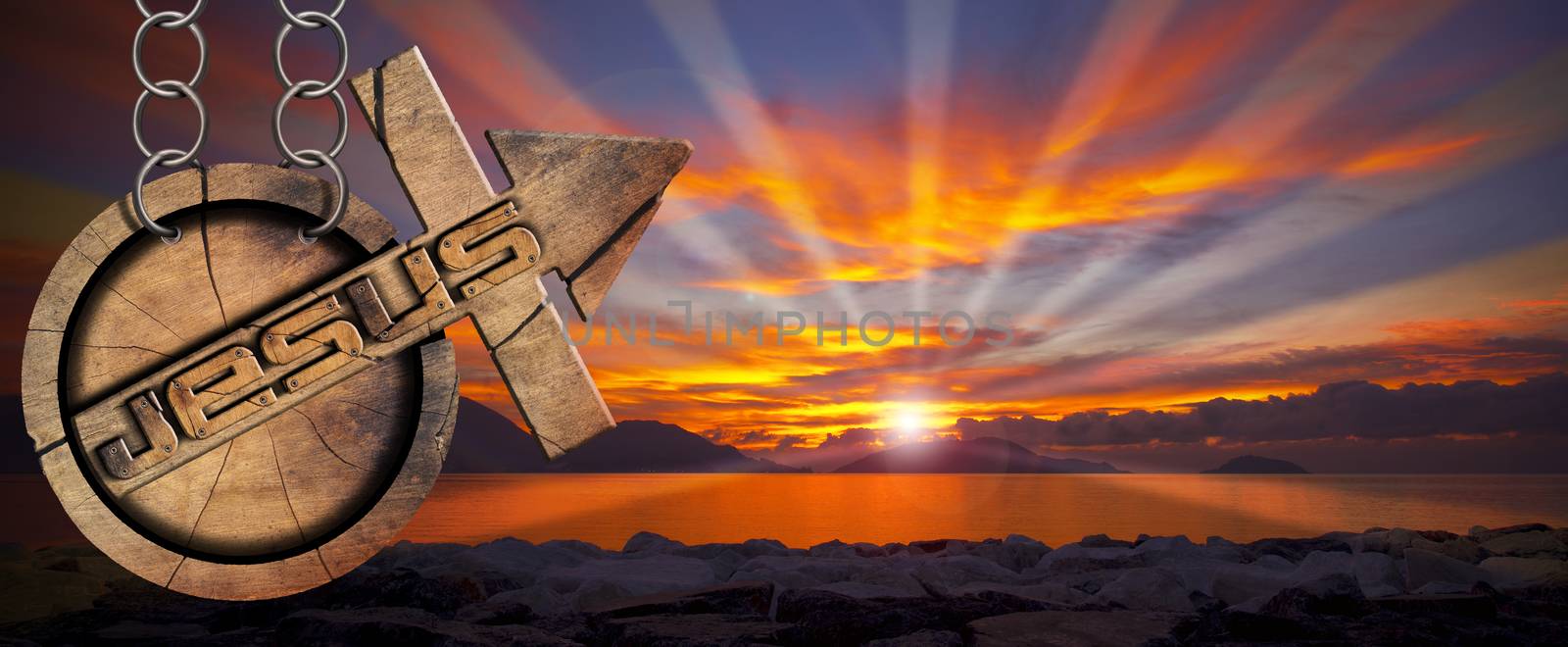 Wooden symbol with cross and arrow upward and text Jesus. Hanging from a chain at a beautiful sunset over the sea with cloudy sky